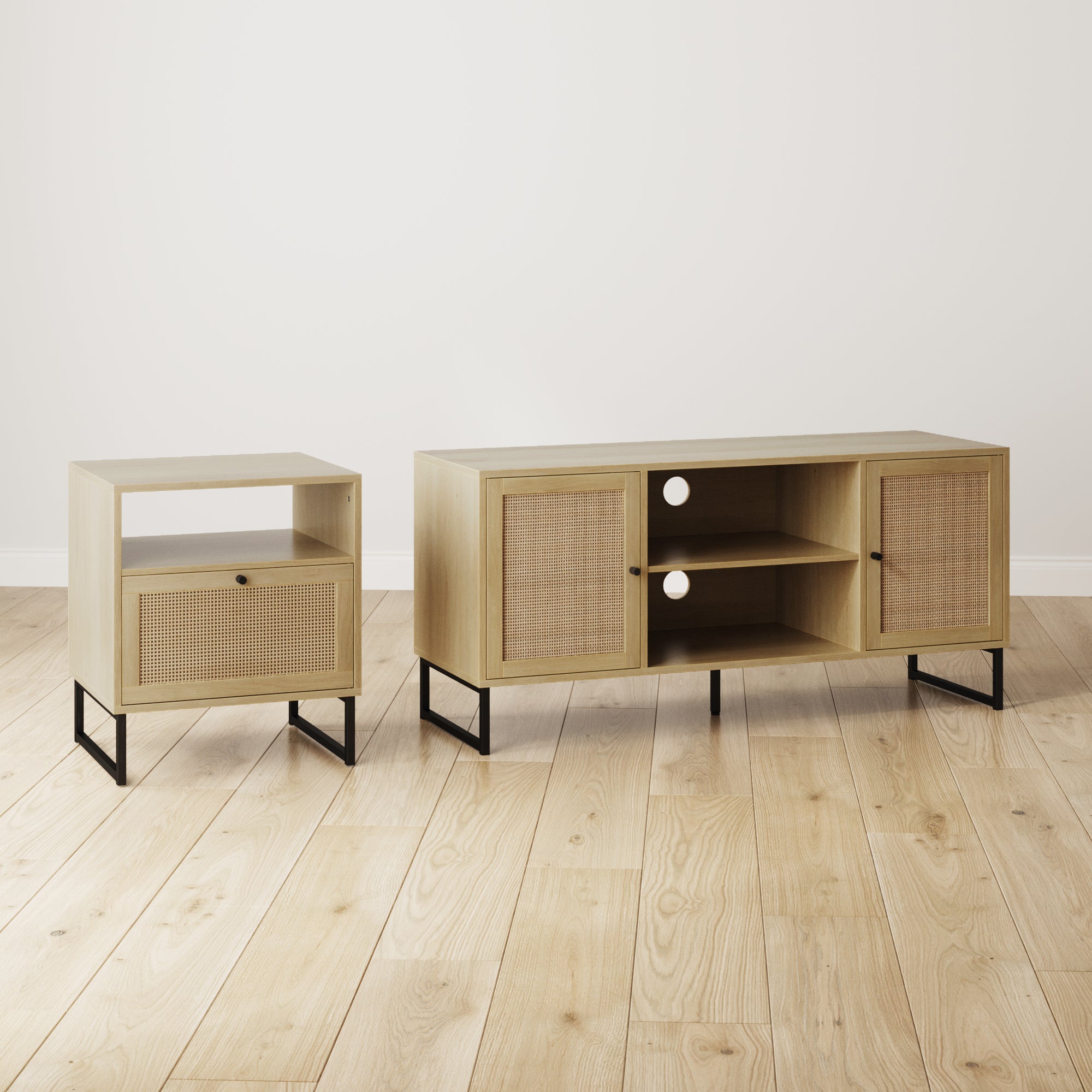 A light wood TV stand and matching side table with cane door fronts and black metal legs sit on a light wood floor against a plain white wall.