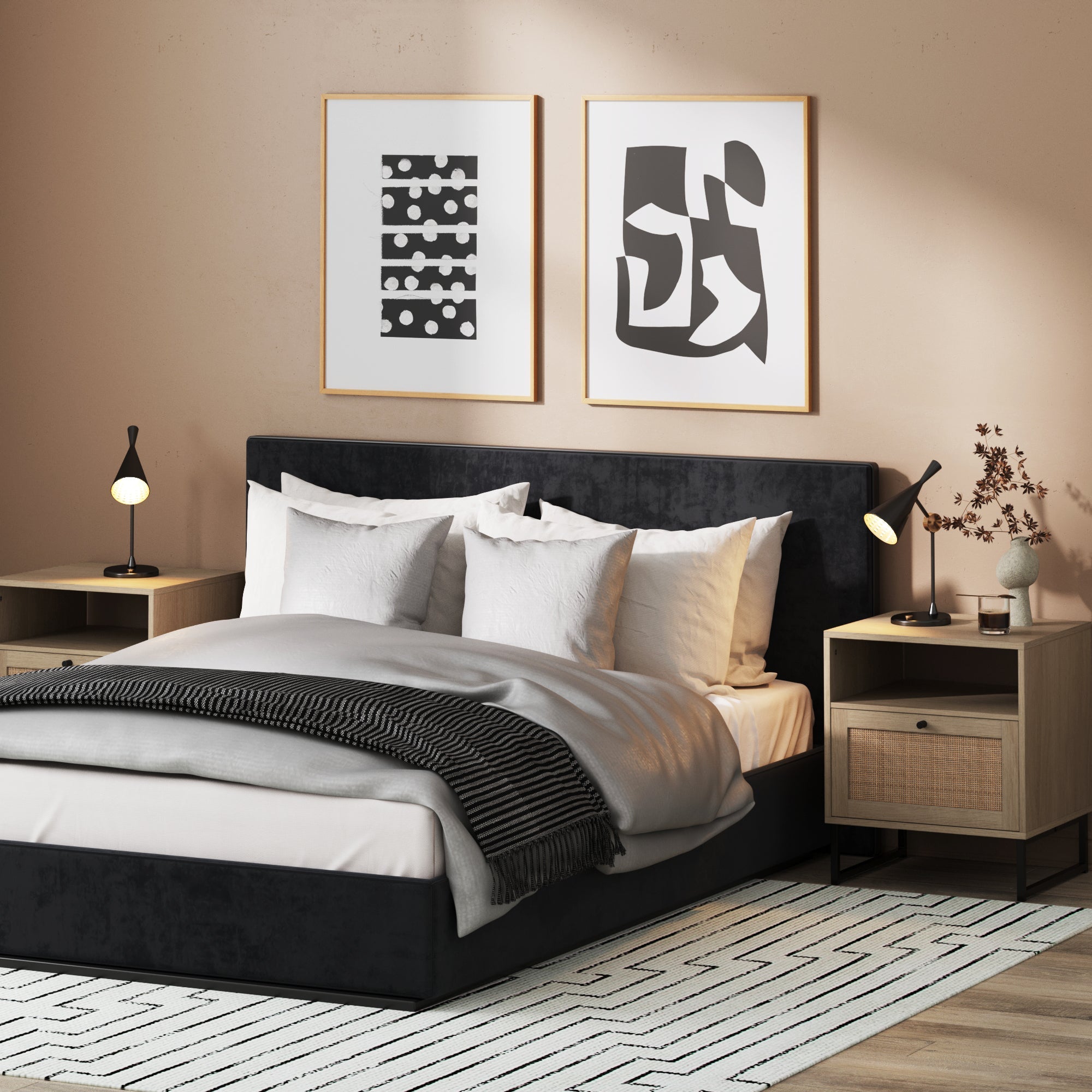 Modern bedroom with a black upholstered bed, white bedding, gray blanket, Nathan James Rattan & Wood Storage Nightstands Oak (Set of 2) with lamps, abstract wall art, and a geometric-patterned rug—an ideal stylish small space solution.