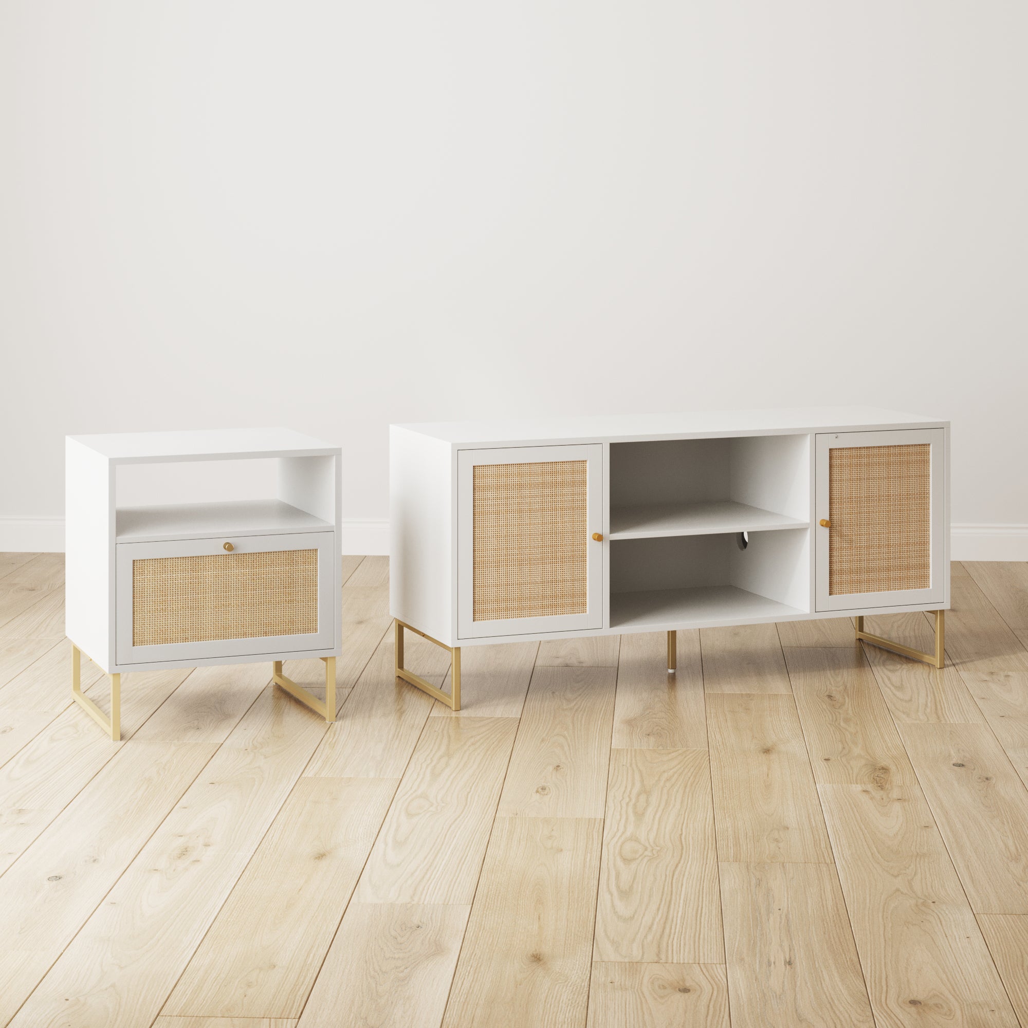 A white nightstand and a white sideboard with gold legs and rattan-fronted doors and drawers, placed on a light wood floor against a plain white wall.