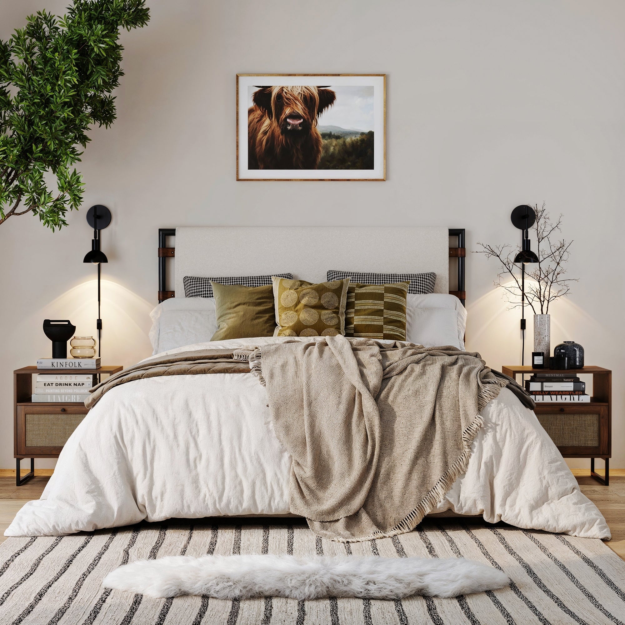 A cozy, modern bedroom features a neatly made bed with green and beige pillows, a beige throw, a striped rug, Nathan James Rattan & Wood Storage Nightstands Walnut (Set of 2), and a framed cow painting for bohemian charm.