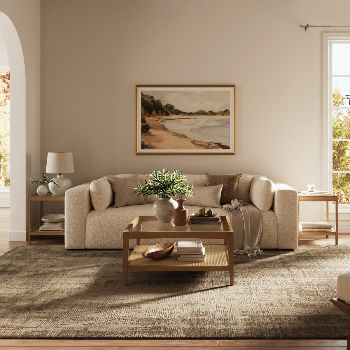 Two square Nathan James Solid Wood Rattan & Glass End Table side tables with natural woven cane lower shelves placed on either side of a beige sofa.