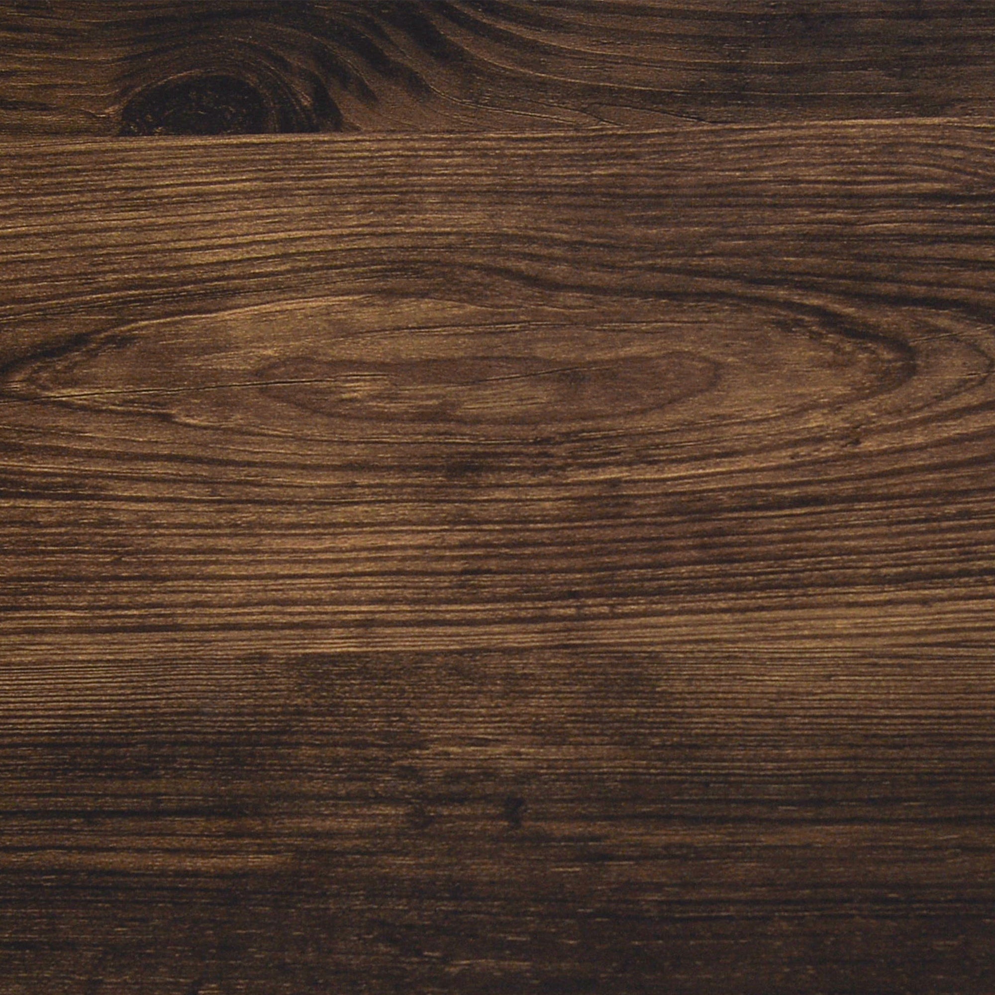 Close-up of a dark brown wooden surface with visible grain patterns and natural knots, giving the wood a textured and rustic appearance.