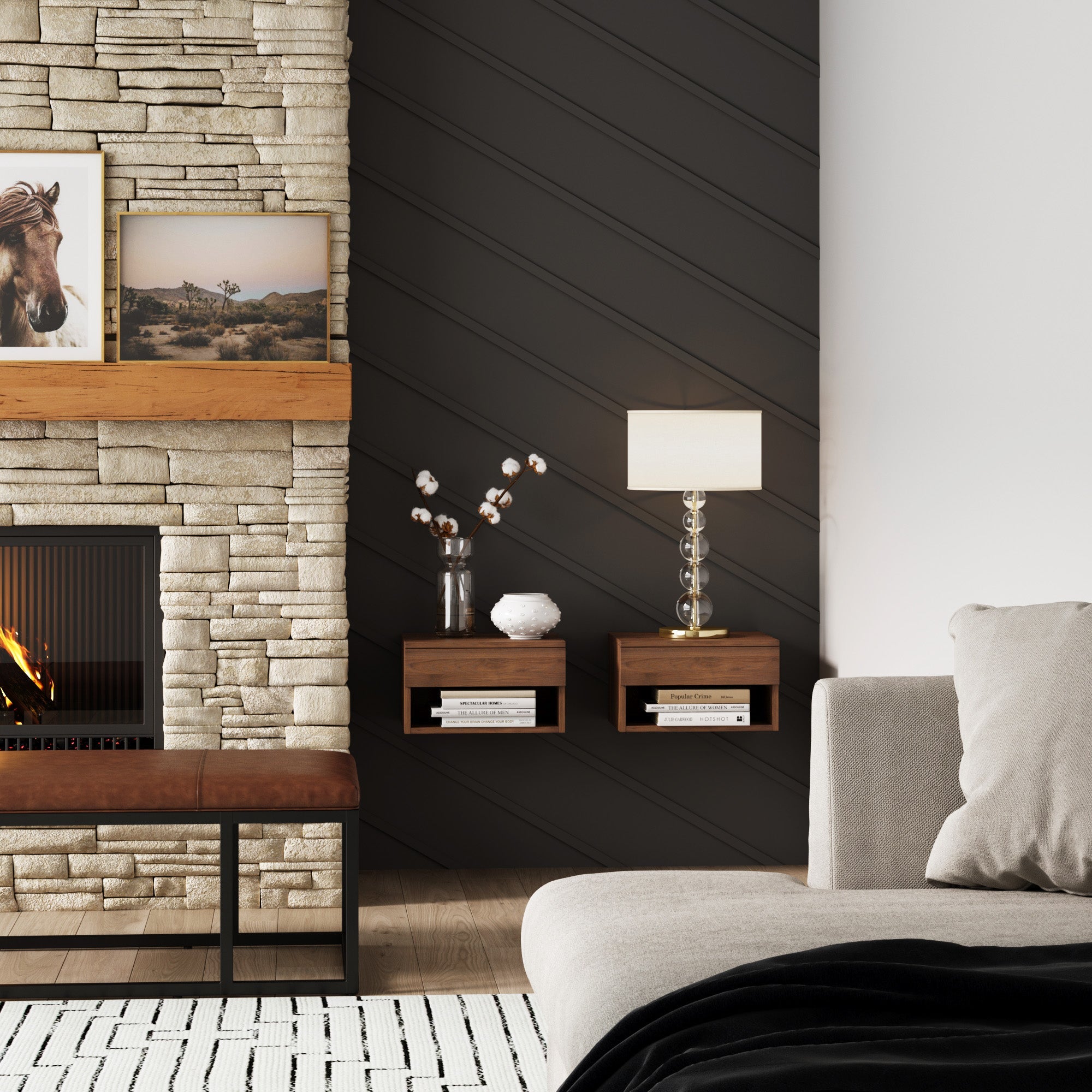 A modern living room featuring a stone fireplace, wooden mantle, framed horse photo, dark accent wall, two floating shelves with decor and lamp, and Nathan James Mid-Century Floating Nightstands Walnut (Set of 2) beside a light sofa on a black and white rug.