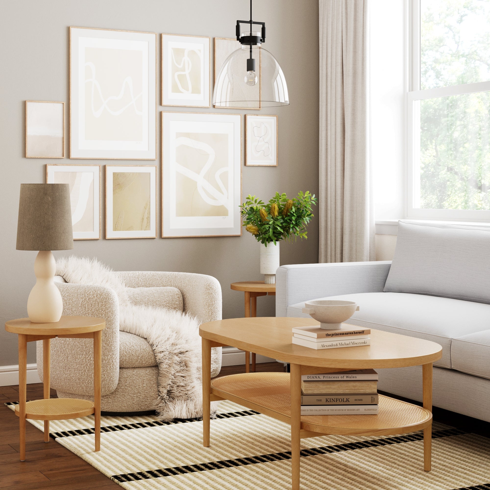 Modern living room with light wood furniture, white sofa, plush armchair, abstract art, and a large window. Nathan James Wood & Rattan Round End Tables (Set of 2) in warm pine and a decorative plant complete the cozy decor.