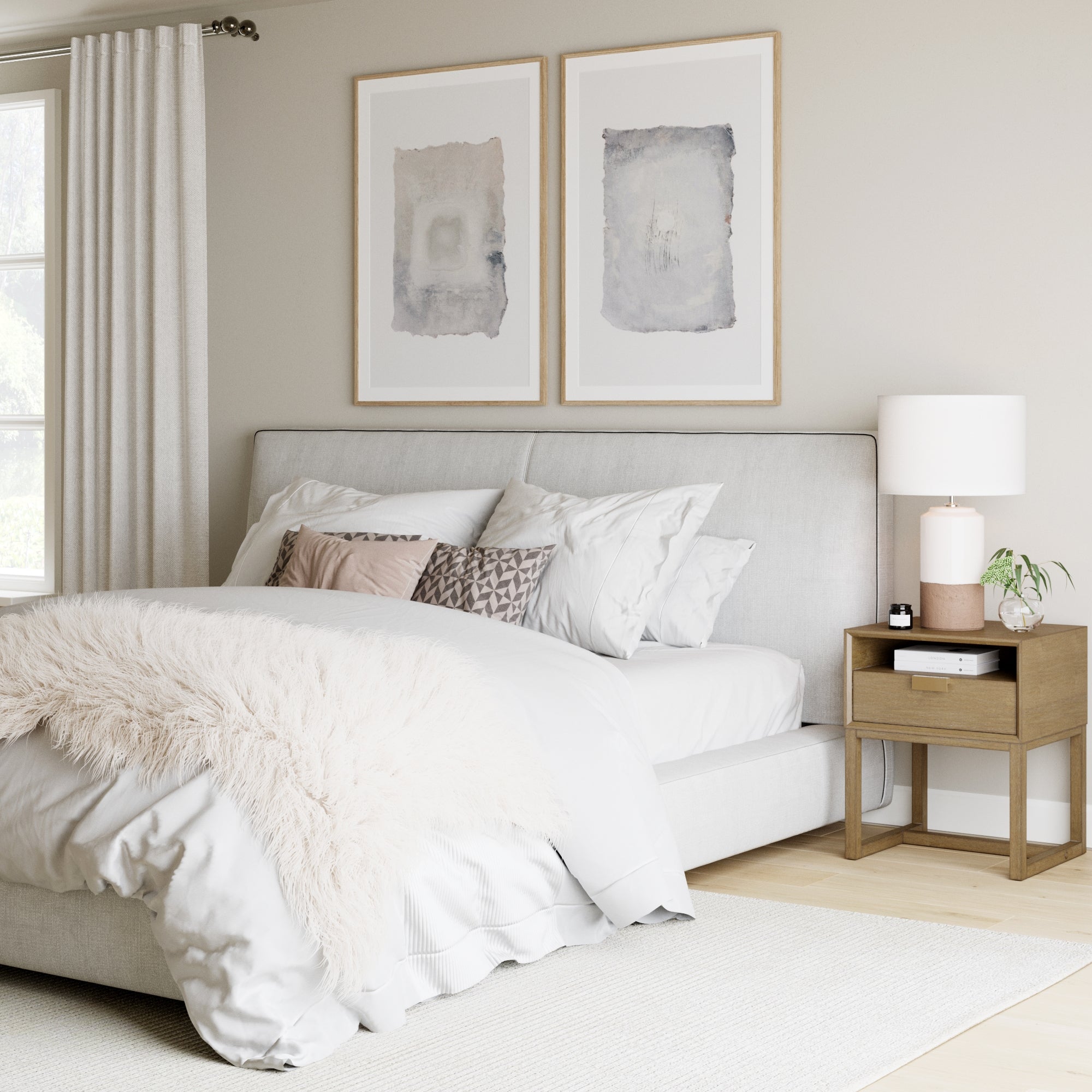 A modern, cozy bedroom with a plush white bed, layered pillows, a soft beige throw, light wood nightstand with a lamp, two abstract art pieces on the wall, white curtains, and neutral decor.