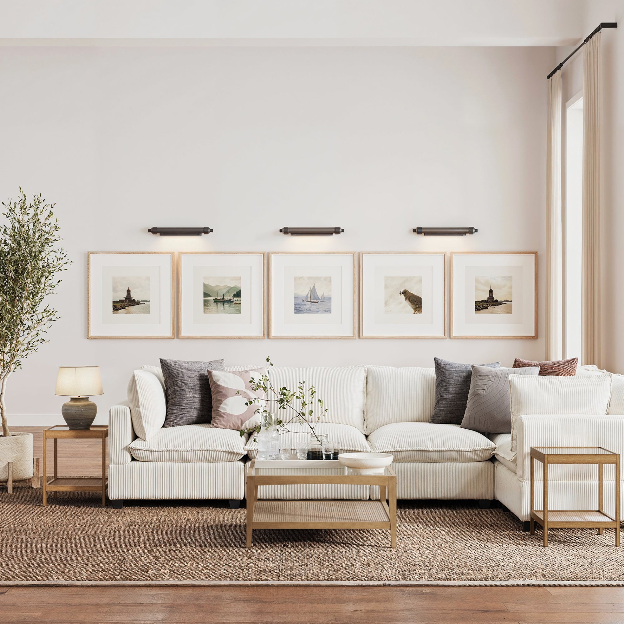 A modern living room featuring the Nathan James Glass 3-Piece Coffee Table Set with Rattan Shelf, a white sectional, neutral pillows, side table with lamp, large rug, framed wall art, and a potted plant—ideal for stylish small spaces.