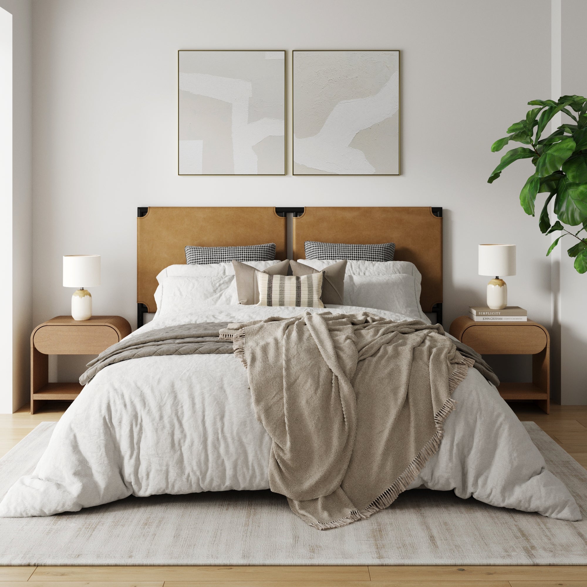 A minimal, bright bedroom with a tan upholstered headboard, white and beige bedding, two Nathan James Mid-Century Arched Nightstand Light Brown nightstands with lamps, abstract art above the bed, and a large leafy plant in the corner.