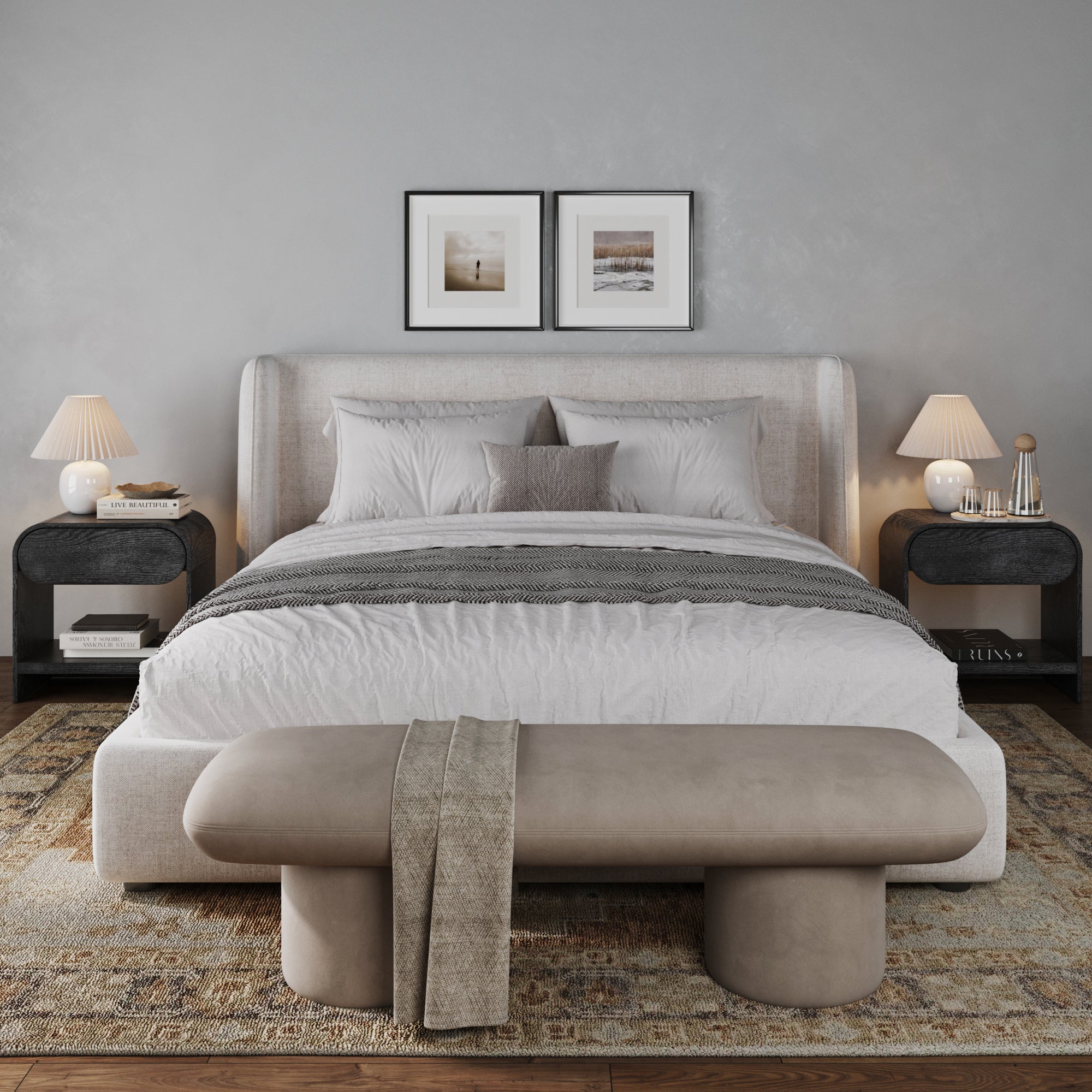 A modern bedroom features a large upholstered bed with neutral bedding, Mid-Century Wood Arched Nightstands by Nathan James in black oak, classic lamps, framed art above the headboard, plus a beige bench and textured rug to complete the space.