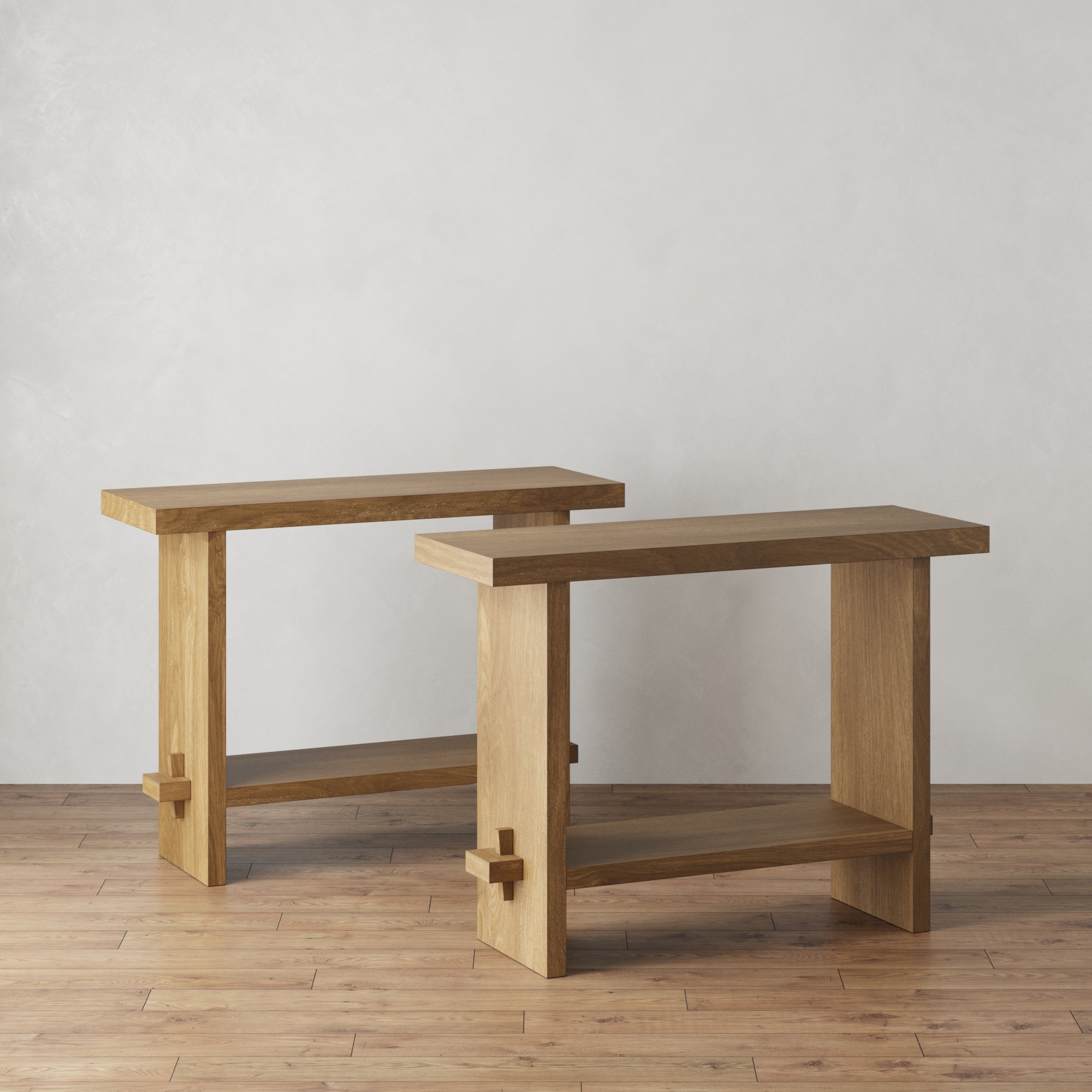 The Nathan James Wood Console Tables Light Brown (Set of 2) feature clean lines and rectangular tops, angled together on a wooden floor against a light textured wall for a modern farmhouse entryway look.