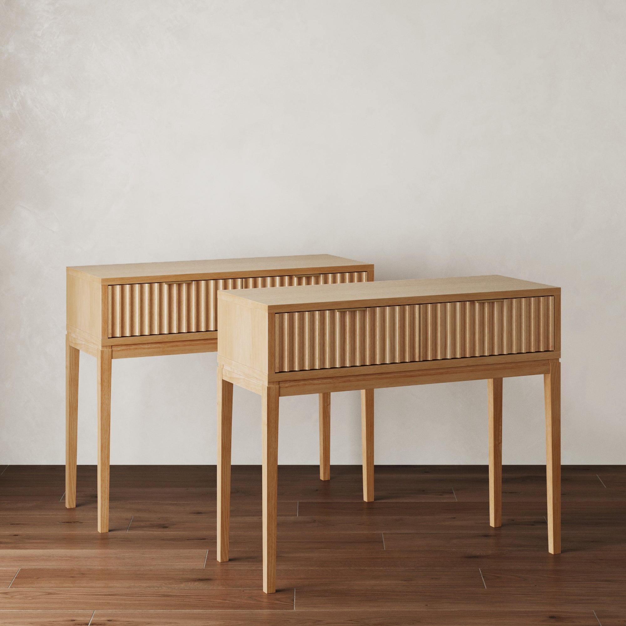 The Nathan James Mid-Century Fluted Console Tables (Set of 2) feature clean lines and minimalist design, with fluted drawer fronts and wooden construction—perfect for entryways or stylish spaces.