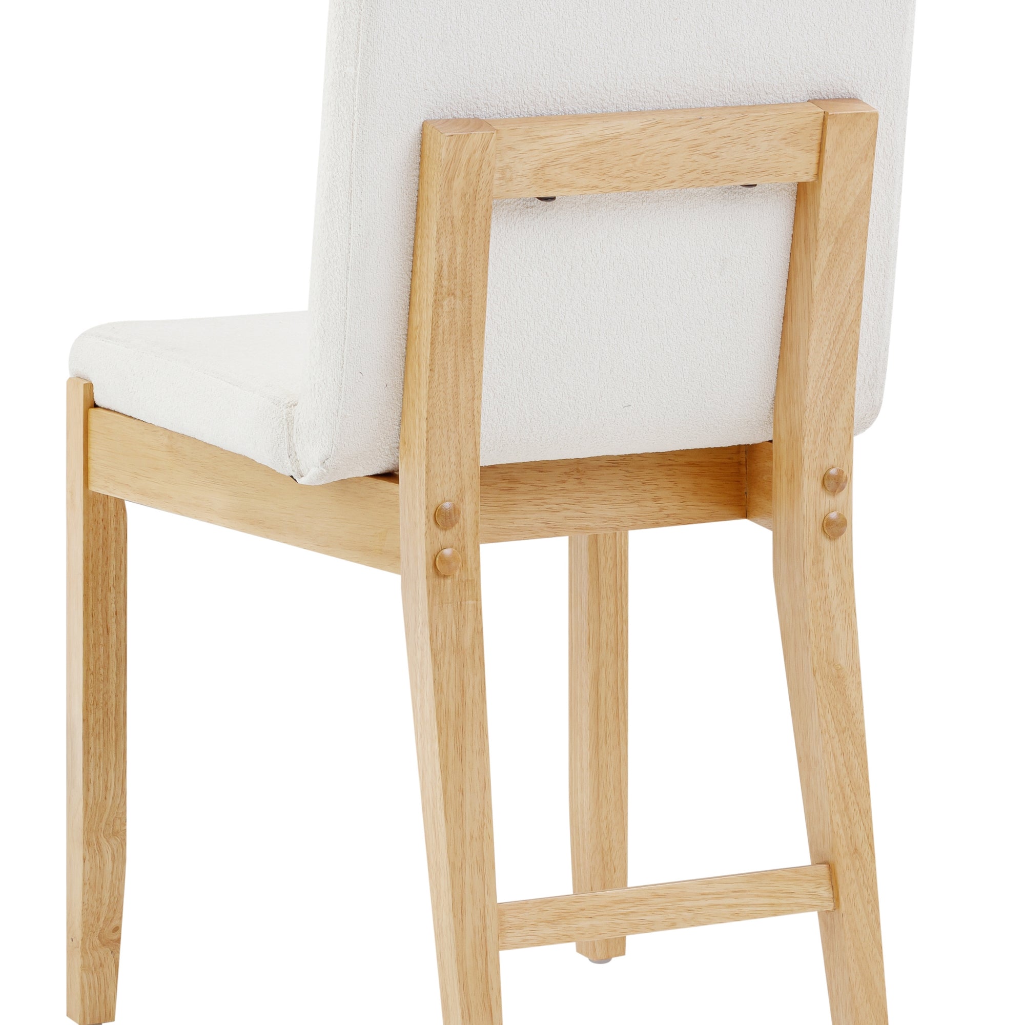 A close-up view of the back and legs of a wooden chair with a light-colored cushioned seat and backrest. The chair has a simple, minimalist design with visible wood grain and clean lines.