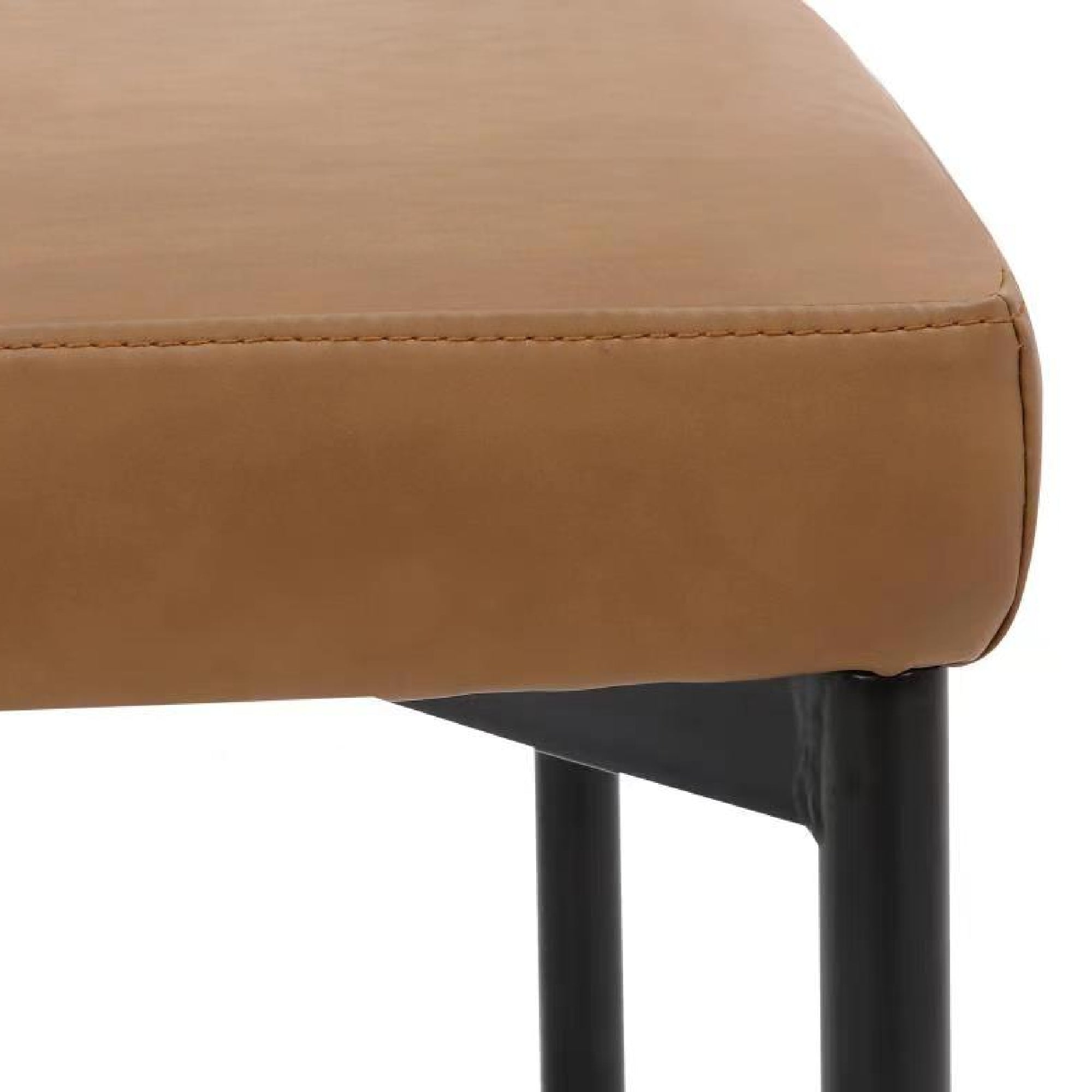 Close-up of a tan upholstered seat cushion with visible stitching, supported by black metal legs. The image shows the corner of the seat and part of the frame.