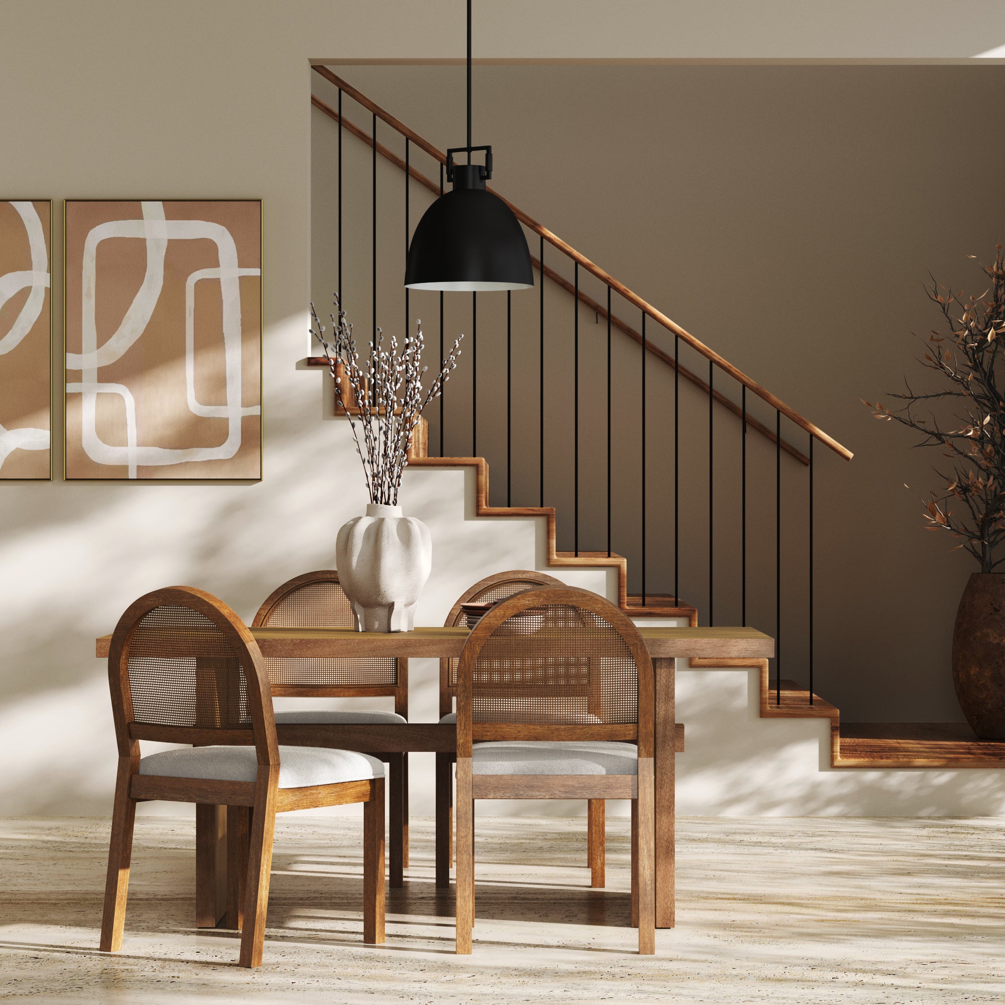 A modern dining area with a wooden table and four chairs, a ceramic vase with branches, abstract art on the wall, a stairway with a wooden banister, and a black pendant light hanging from the ceiling.