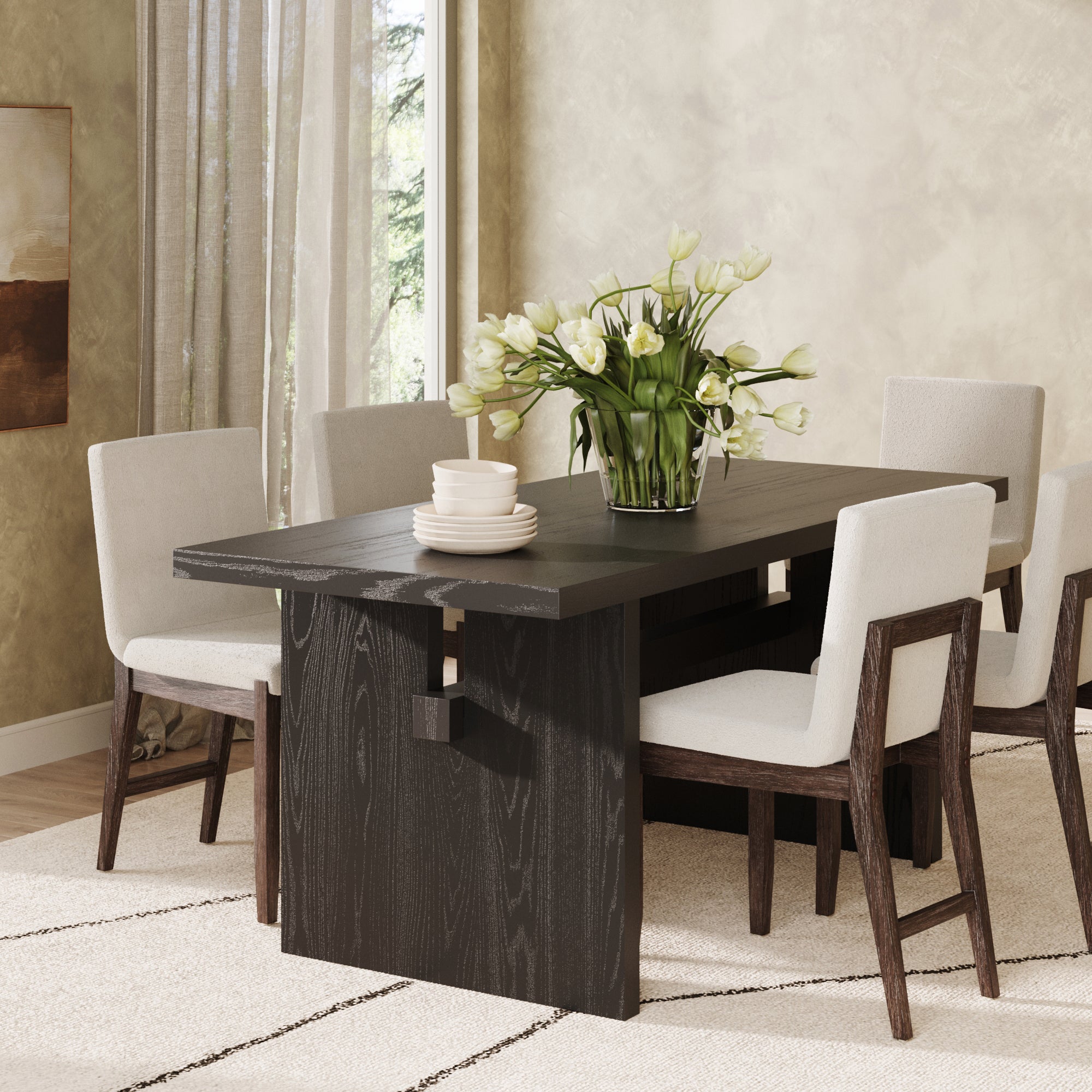 A modern dining room features the Nathan James Wood Modern Farmhouse Dining Table in Black Oak for 6, paired with six upholstered wooden chairs, a white tulip centerpiece, and neutral decor with light walls and sheer curtains.
