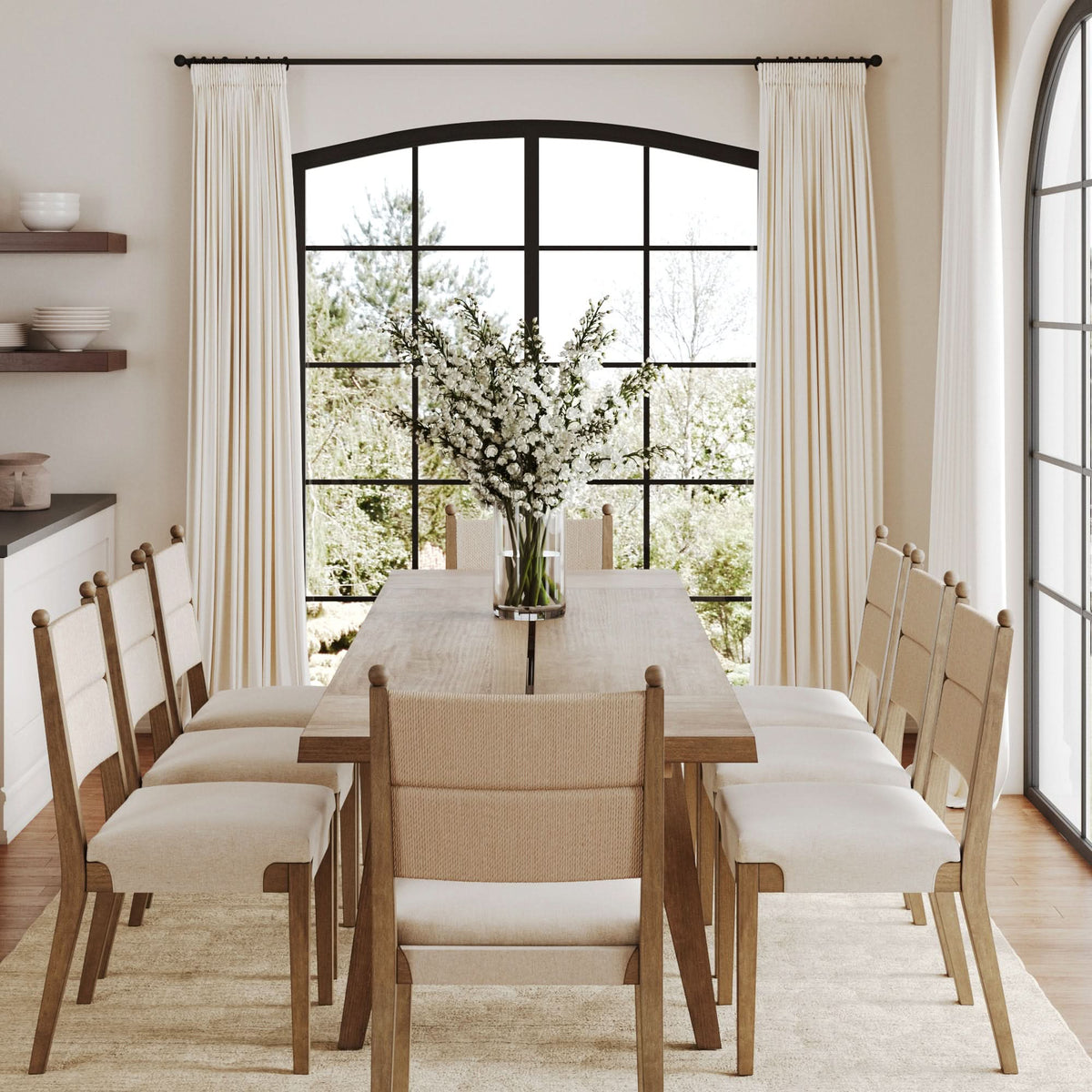 Light brown Farmhouse Extendable Wood Dining Table with Leaf Extensions with eight upholstered chairs arranged in a sunlit dining room.