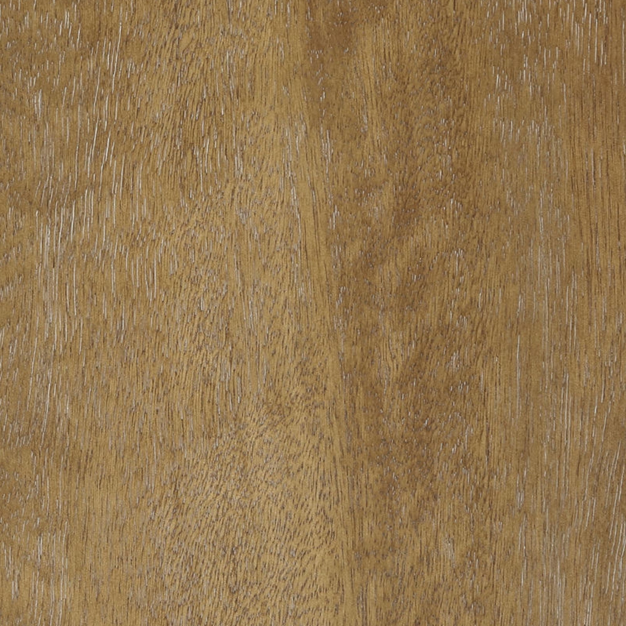 Close-up of a wooden surface with a golden-brown color, visible natural grain patterns, and subtle texture variations. The wood appears smooth and polished with linear streaks and small speckles.