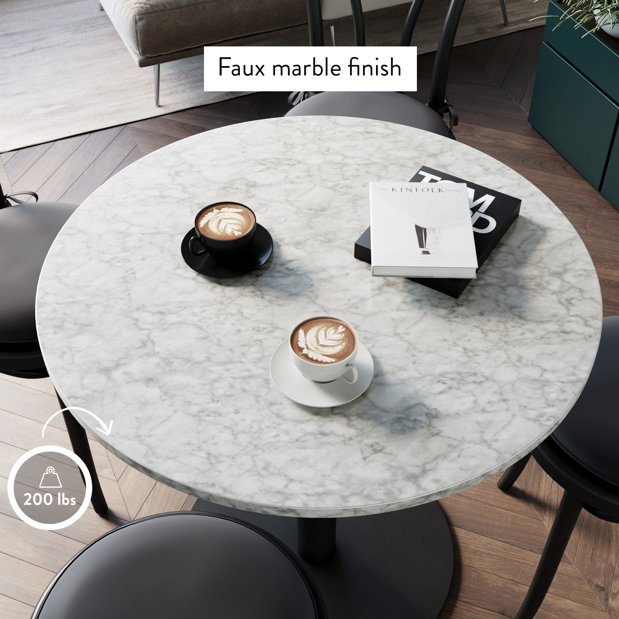 Round table with a faux marble finish, holding two cups of coffee with latte art, a magazine, and surrounded by black chairs. A label indicates a 200 lb weight capacity.