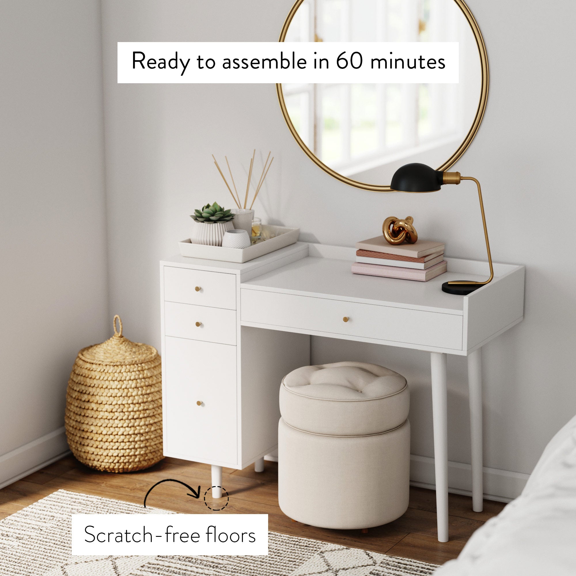 A modern white vanity desk with gold accents sits in a bright room with a round mirror, lamp, books, and decor. A cushioned stool and basket are nearby. Text reads: Ready to assemble in 60 minutes and Scratch-free floors.