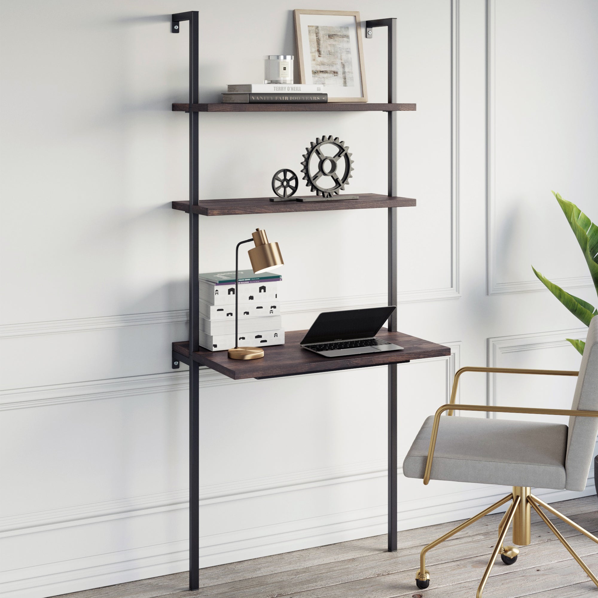 The Nathan James Wood Wall Mount Ladder 2-Shelf Desk in Nutmeg, paired with modular shelving and a modern chair, creates a bright, space-saving office. White paneled walls and a green plant complete the minimalist look—ideal for small spaces.