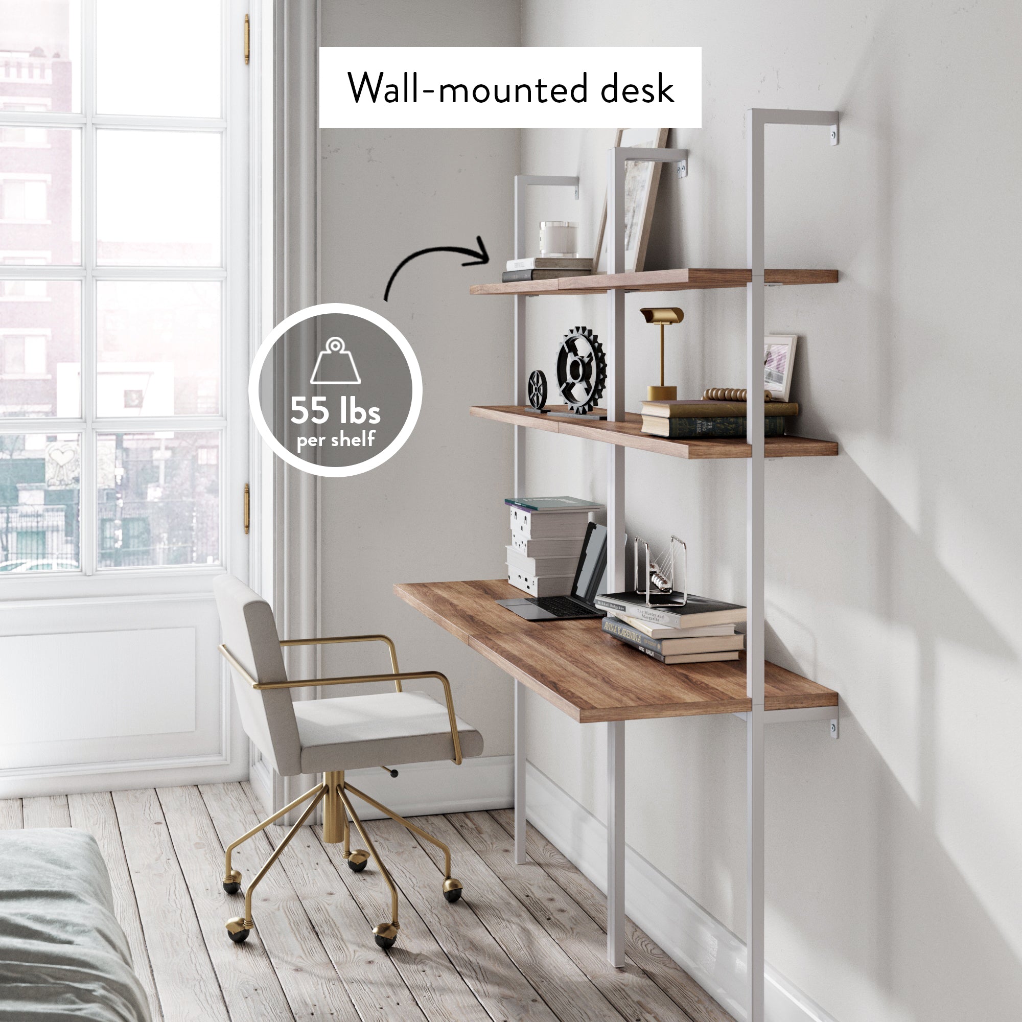 A modern wall-mounted desk with wooden shelves holds books, decor, and office supplies. A white and gold swivel chair sits in front. Text: Wall-mounted desk, 55 lbs per shelf. Sunlight streams through a large window.