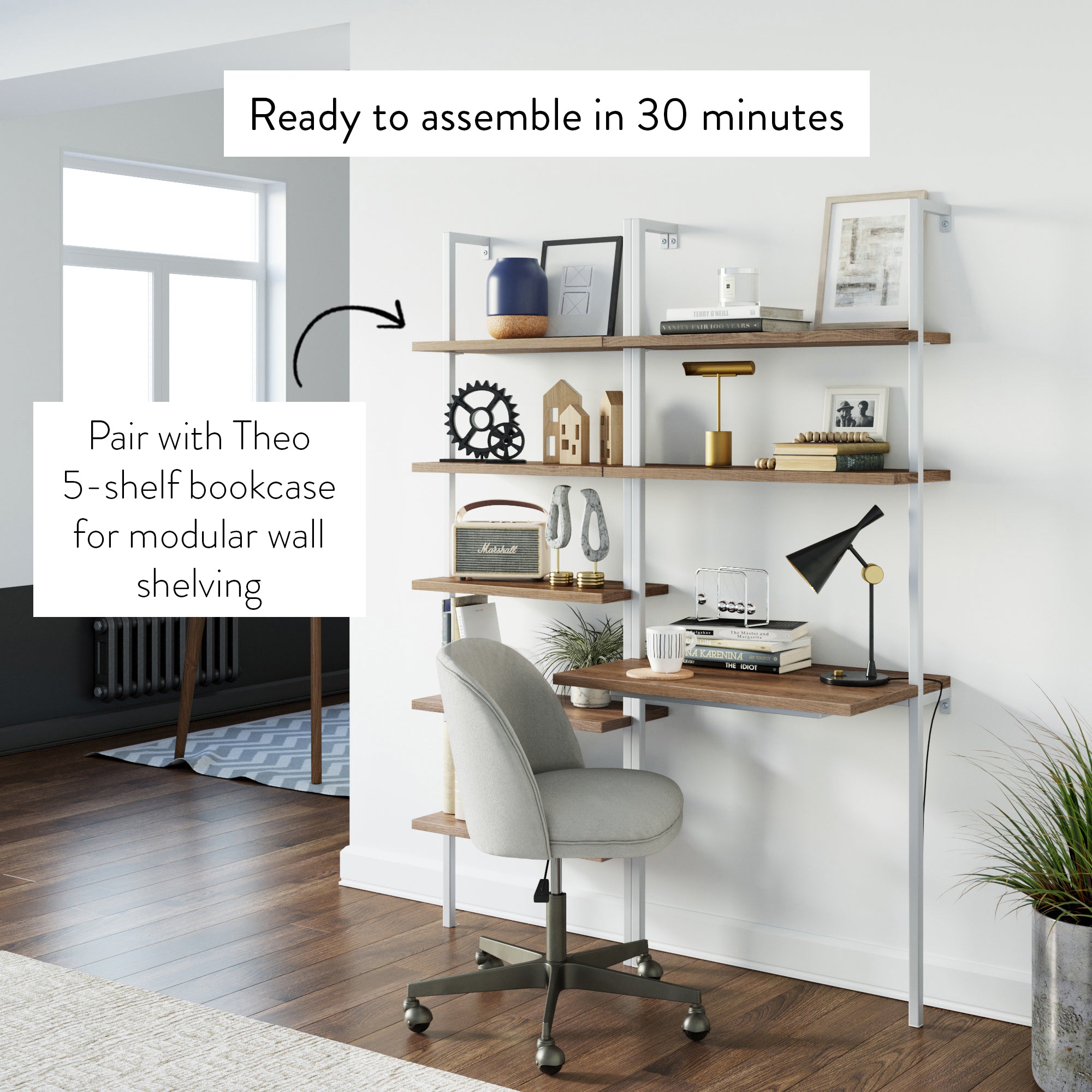 A modern home office features a wall-mounted desk with shelves holding books, decor, a lamp, and a clock. A gray chair is at the desk. Text reads: Ready to assemble in 30 minutes and Pair with Theo 5-shelf bookcase.