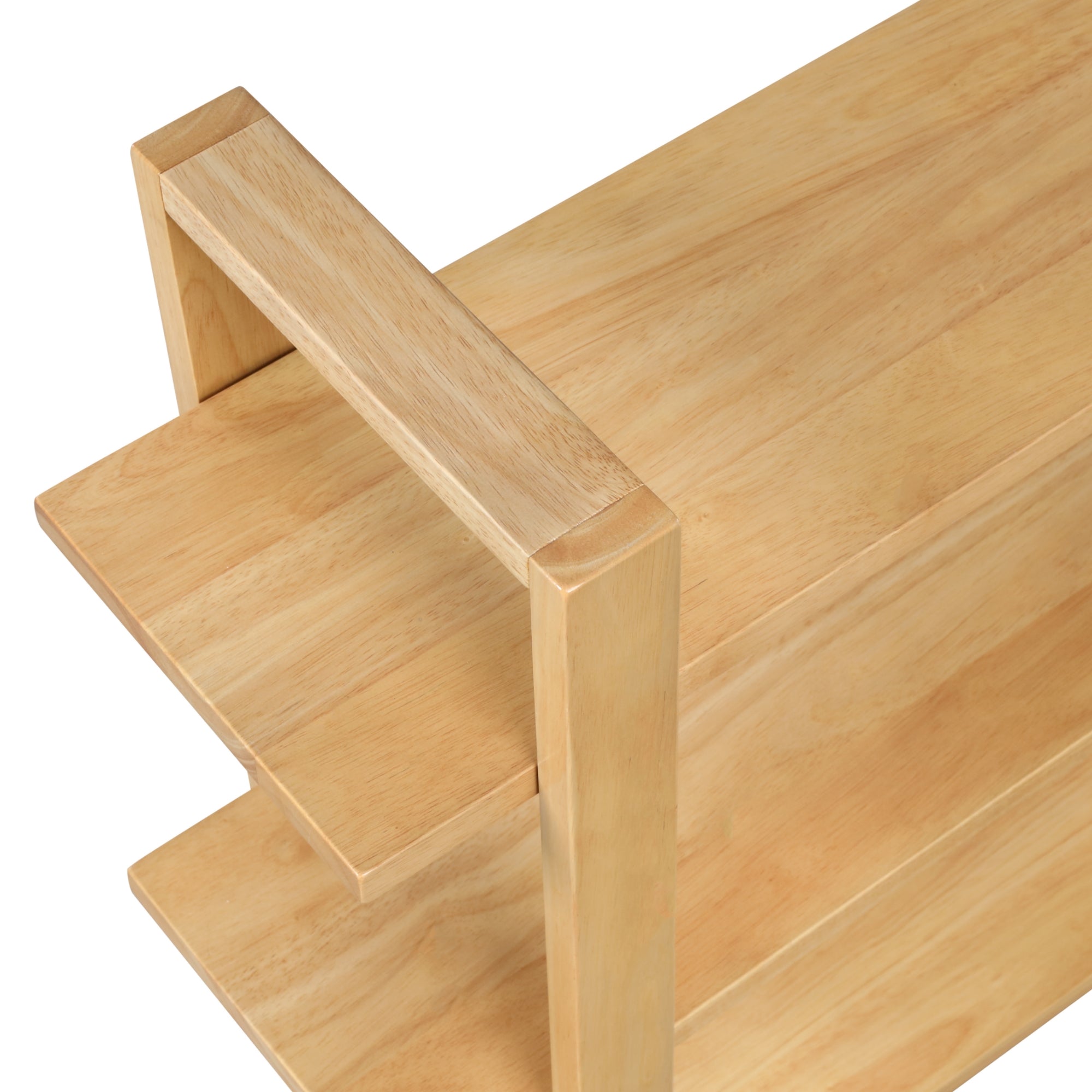 A close-up view of a light wood shelf unit with two tiers and a simple, modern design featuring clean lines and rectangular shapes.