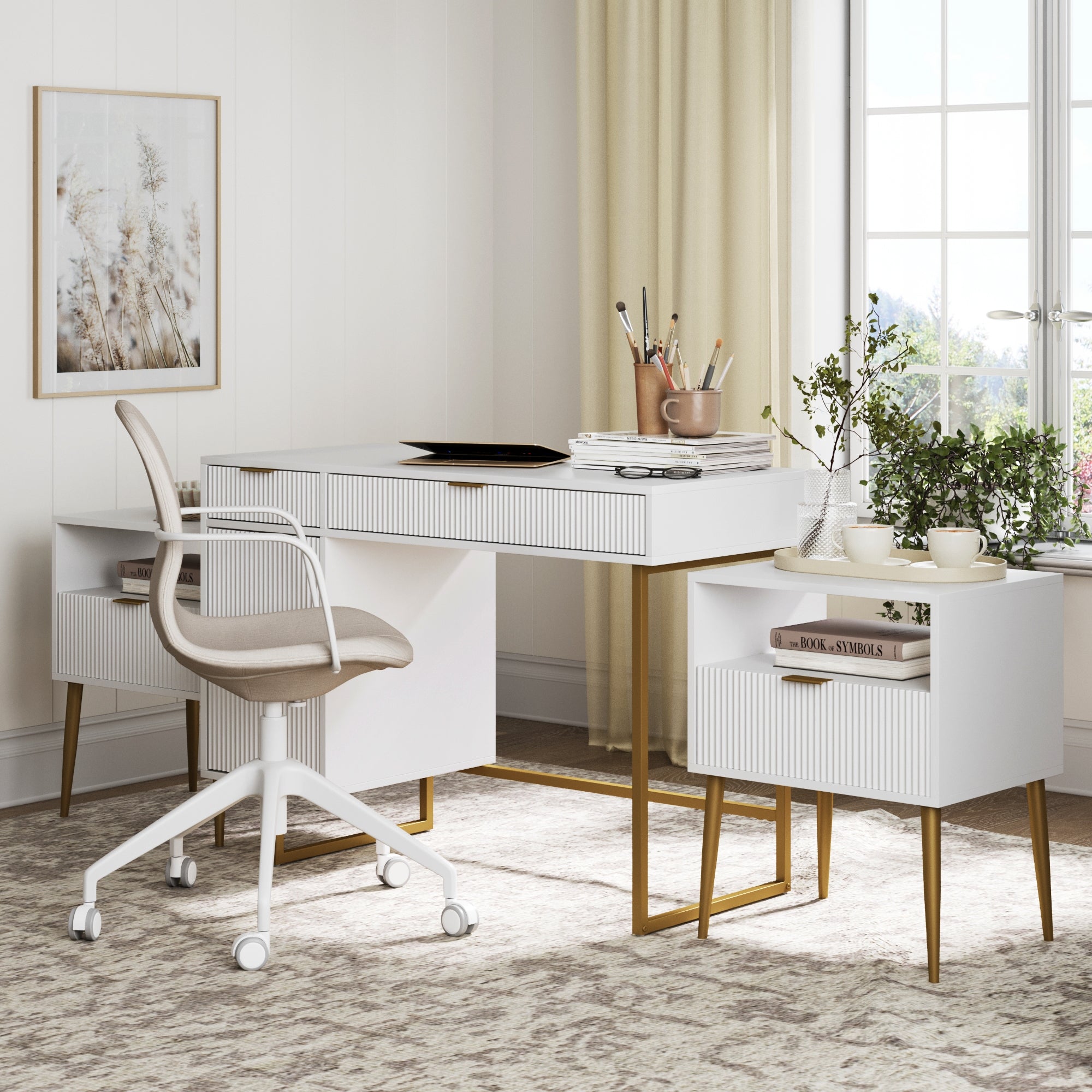 A modern home office featuring the Nathan James Fluted Desk & 2 Nightstands Bedroom Vanity Set, paired with a white swivel chair, plants, art supplies, books, and decor. Sunlight glows through beige curtains in this cozy neutral-toned space.
