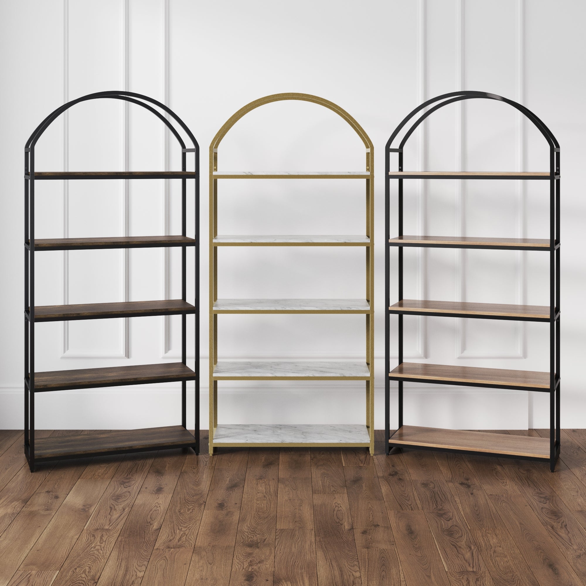Three Nathan James Wood & Metal 5-Shelf Arched Bookshelves in matte black stand side by side against a white paneled wall. The shelves are wood, except for the middle unit, which features white marble shelves. The floor is medium brown wood.