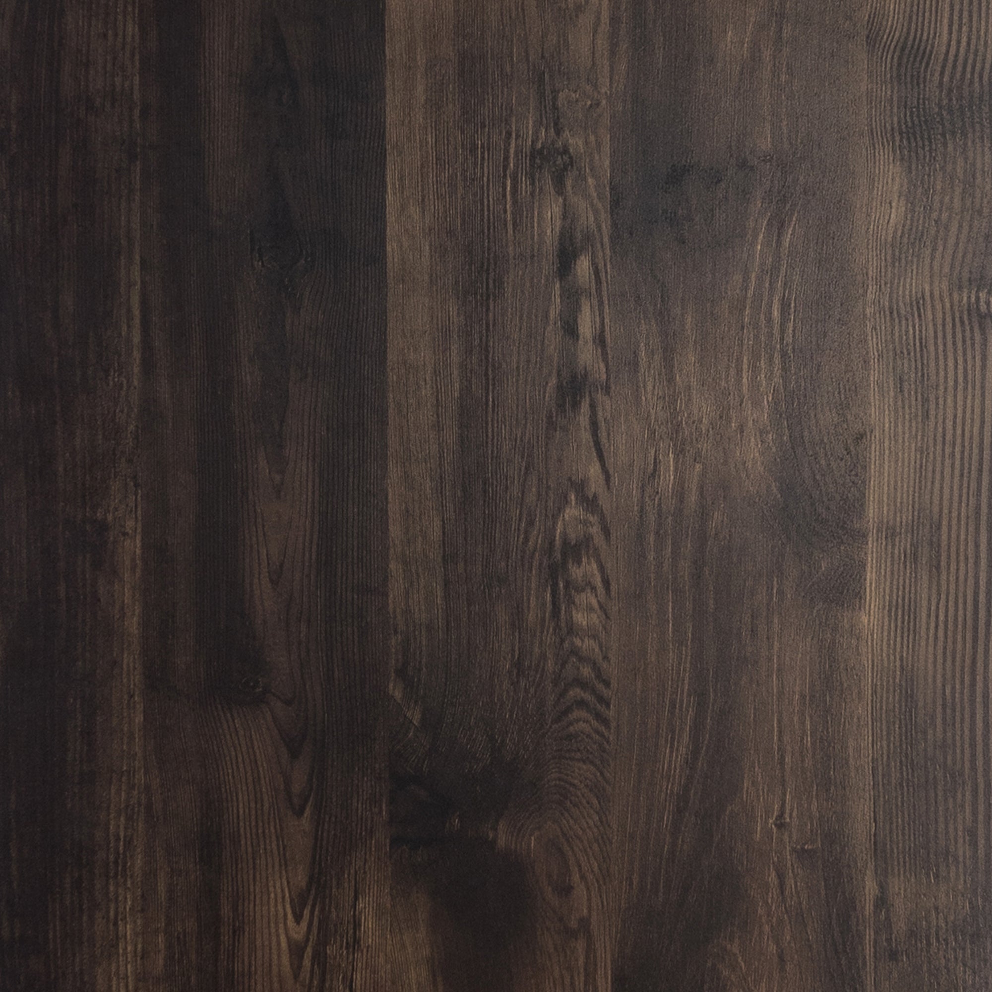 A close-up view of a dark brown wooden surface with visible natural grain patterns and subtle texture variations.
