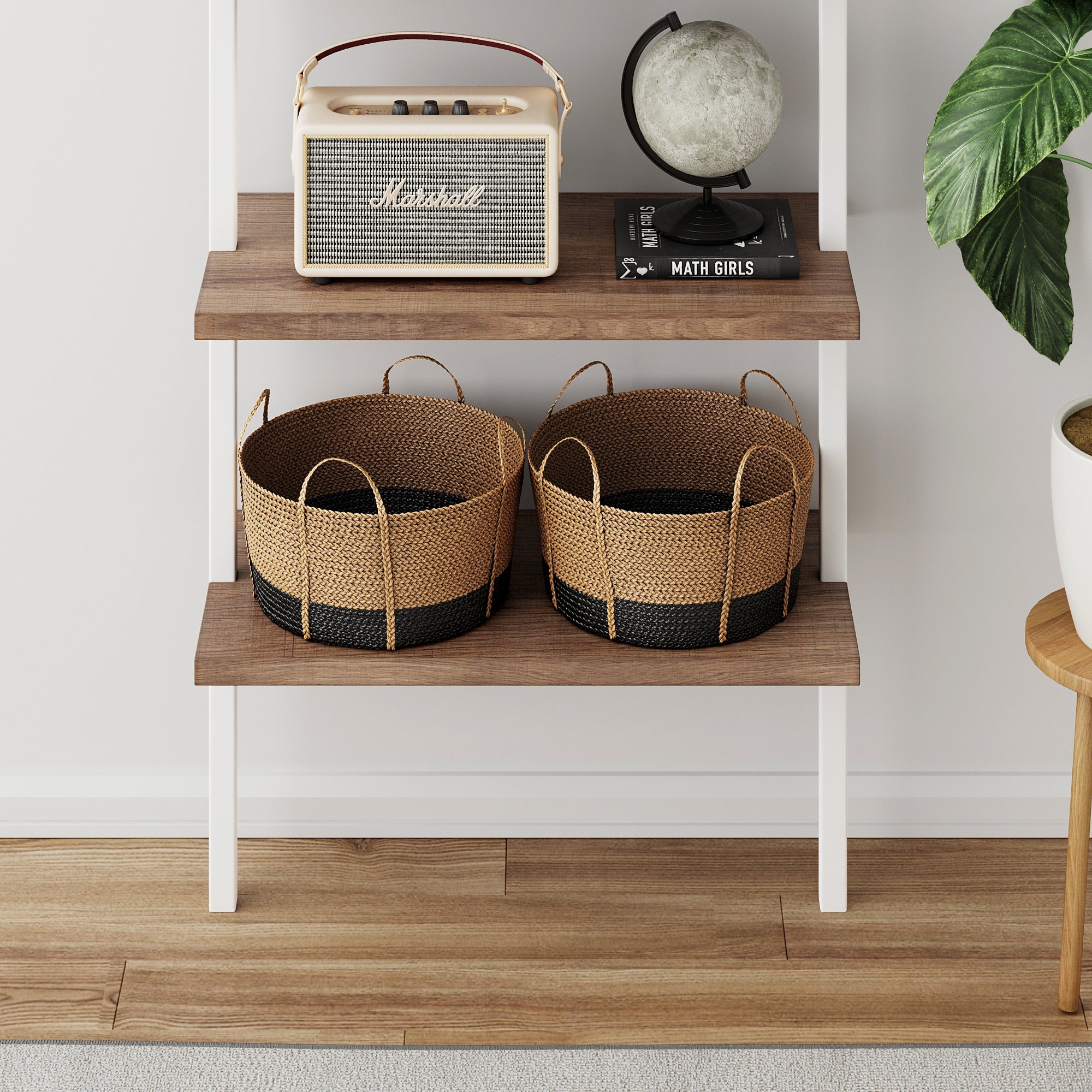 A shelf with a retro radio, a globe, a small stack of books, a potted plant, and two woven baskets on a lower shelf, set against a white wall and wooden floor.