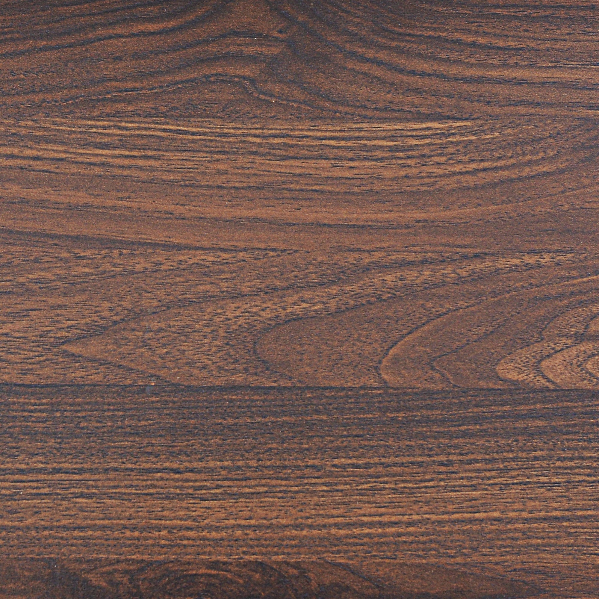 Close-up of a wooden surface with a rich brown color and visible natural grain patterns. The texture includes swirls, lines, and knots, giving the wood a warm, organic appearance.