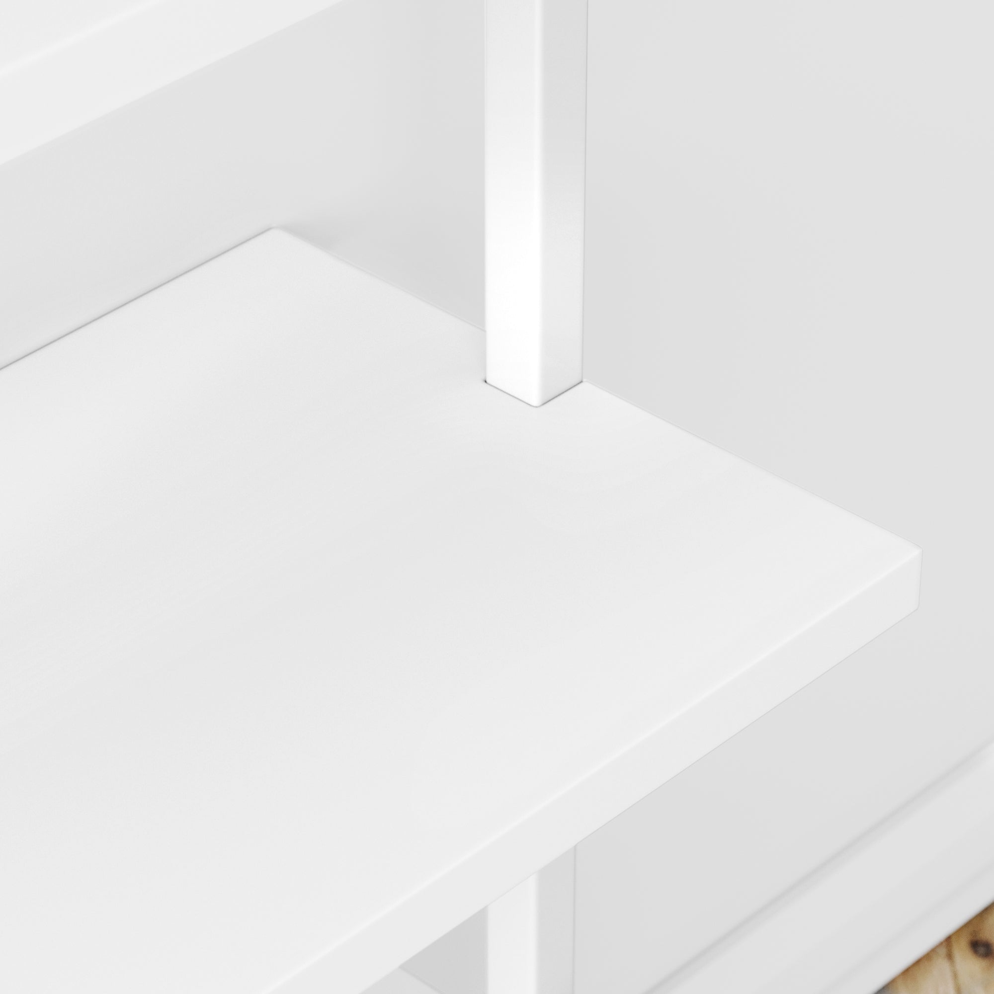 A close-up view of a white wooden shelf with clean lines and a right-angle corner, attached to a vertical support on a white background.