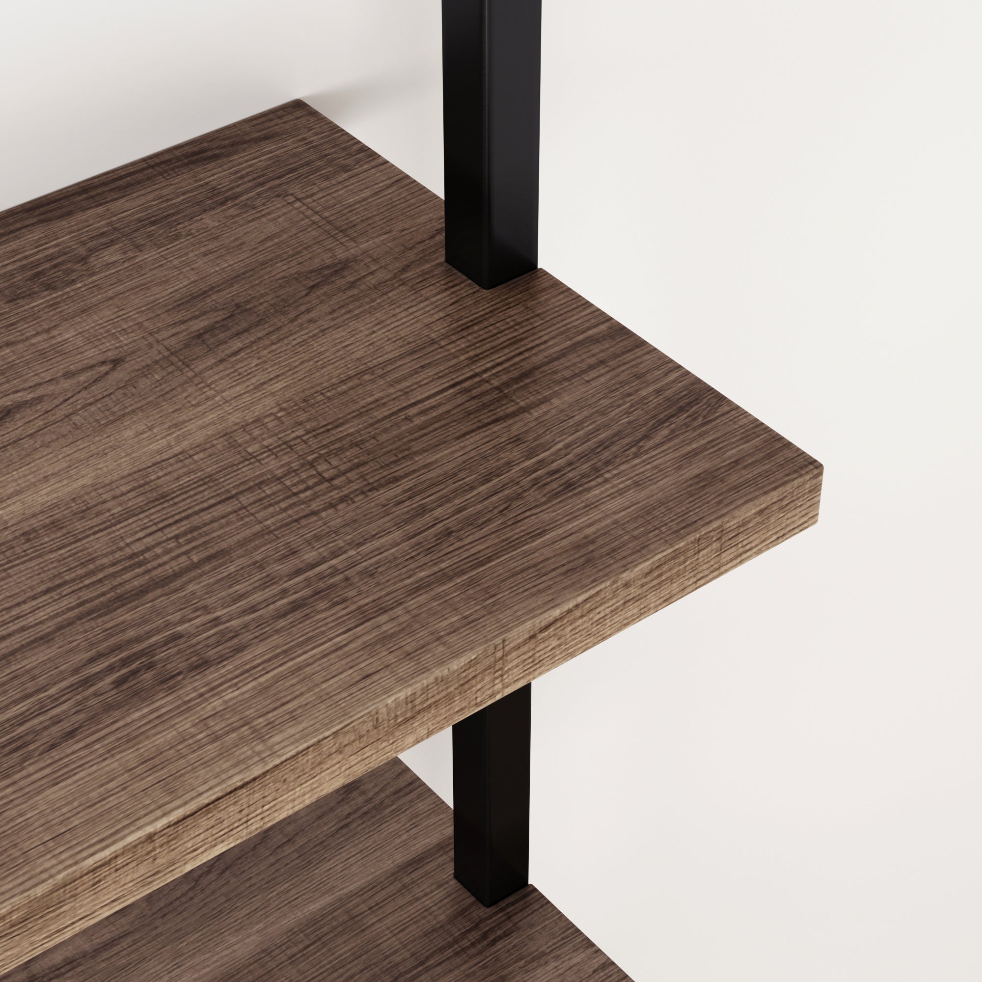 Close-up view of two wooden shelves with a dark grain pattern, supported by black metal brackets against a plain white background.