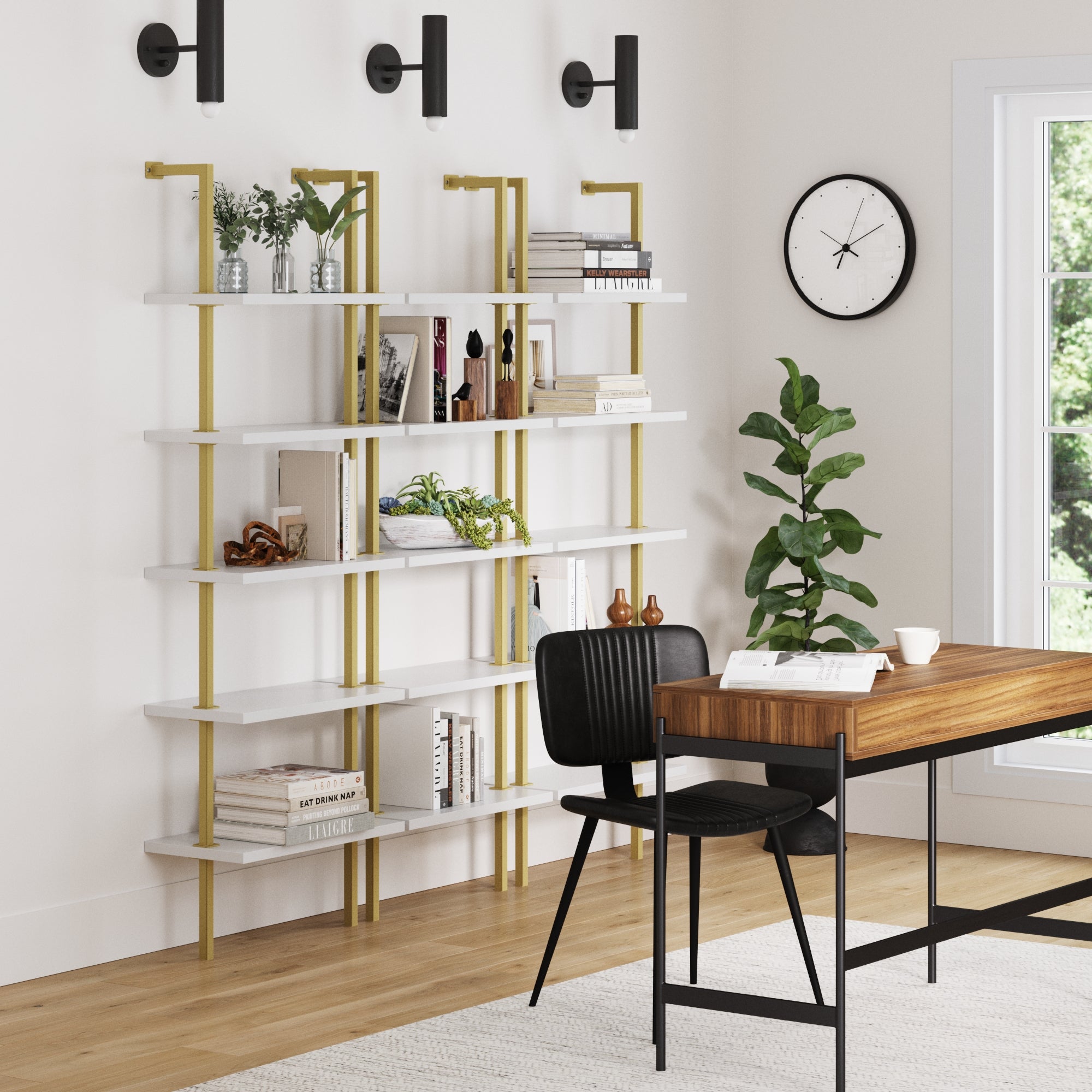A modern home office features a wooden desk, black chair, and Nathan James 5-Shelf Ladder Wall Bookshelves in white and gold (set of 3), styled with books and decor. A leafy plant, wall clock, and bright window complete the contemporary space.