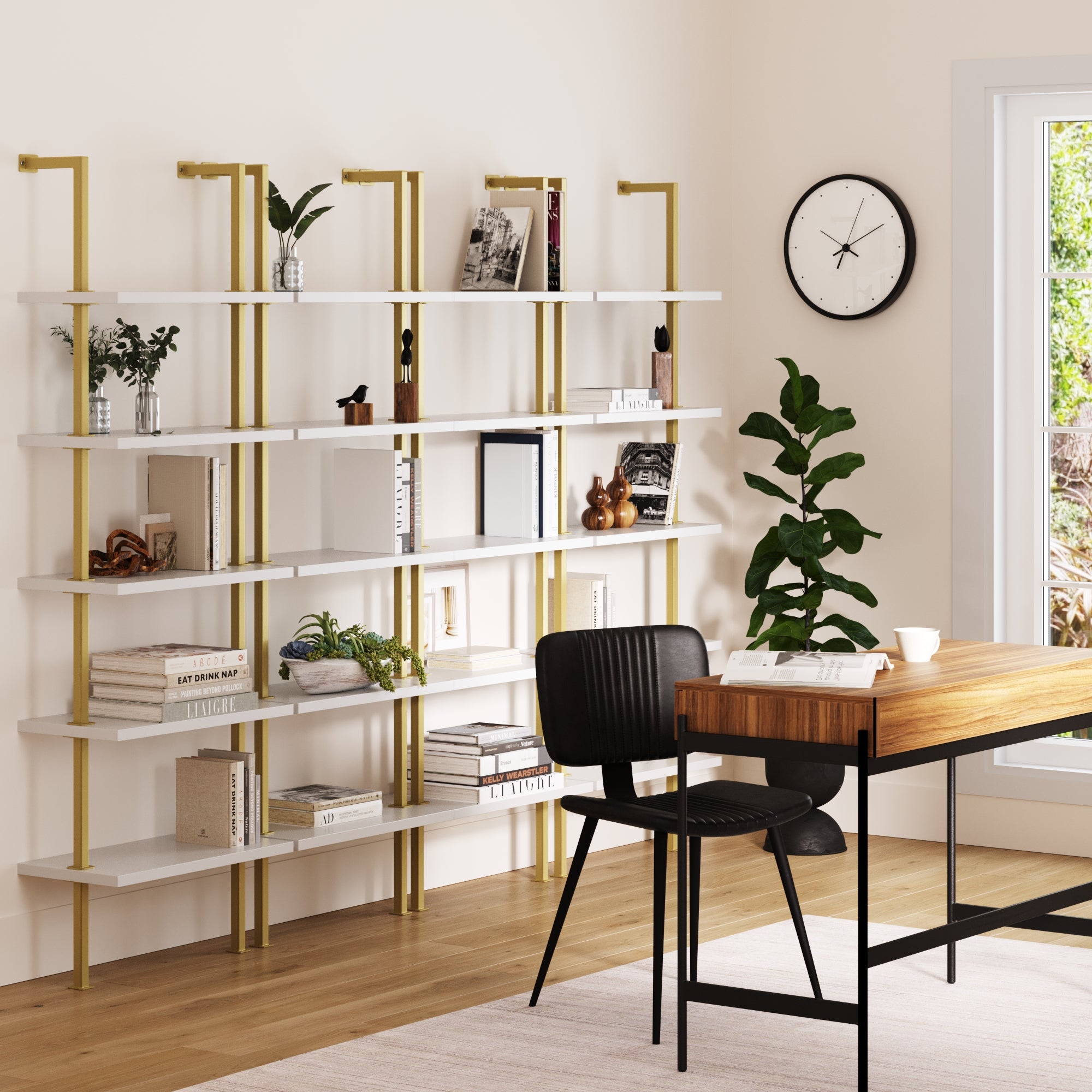 Modern home office with a wooden desk, black chair, wall clock, potted plant, and a Nathan James 5-Shelf Ladder Wall Bookshelves White Gold (Set of 4) displaying books and decor near a window.