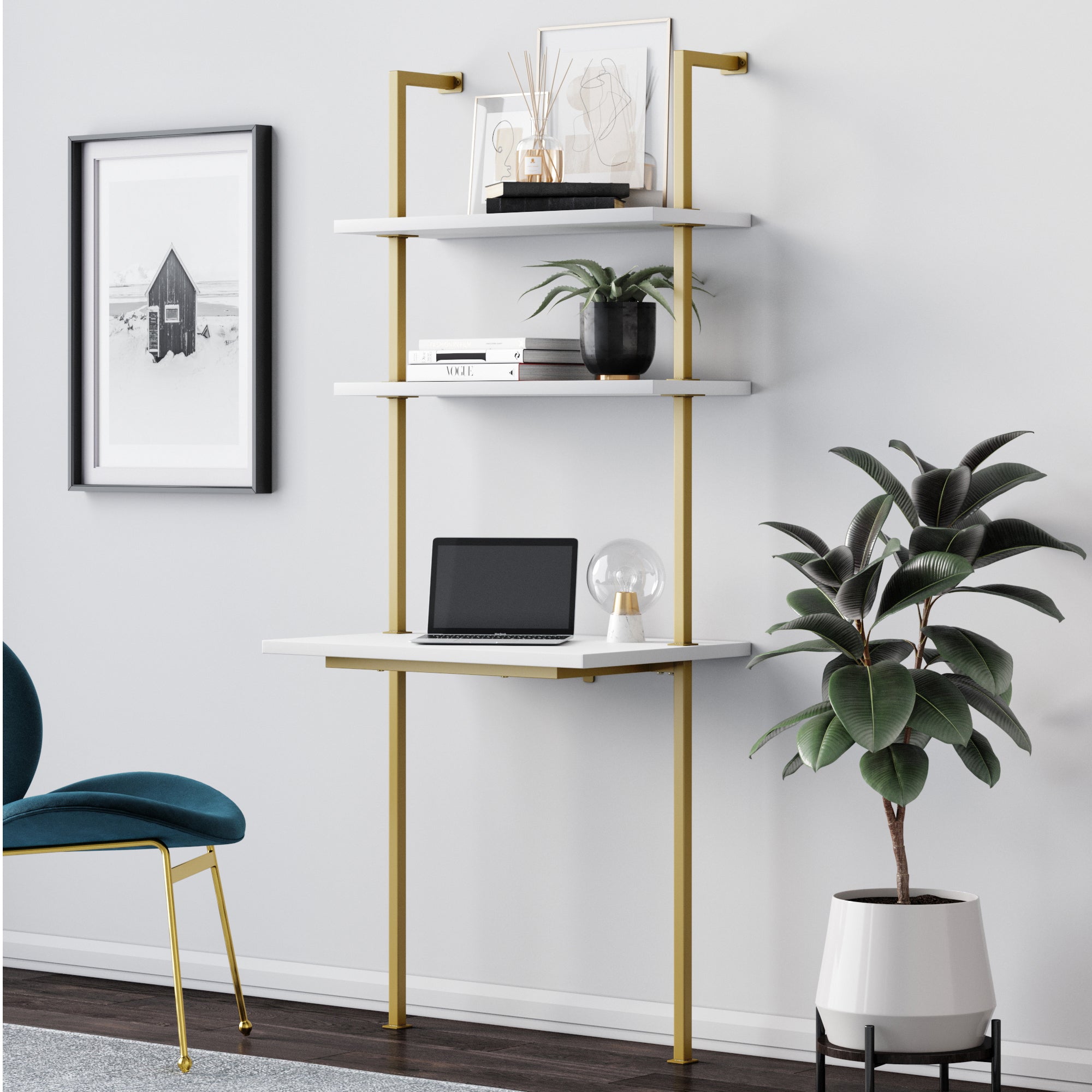 A modern home office for small spaces features the Nathan James Wood Wall Mount Ladder 2-Shelf Desk in nutmeg, a laptop, lamp, modular shelves with books and decor, a teal chair below a framed picture, and a potted plant on the floor.
