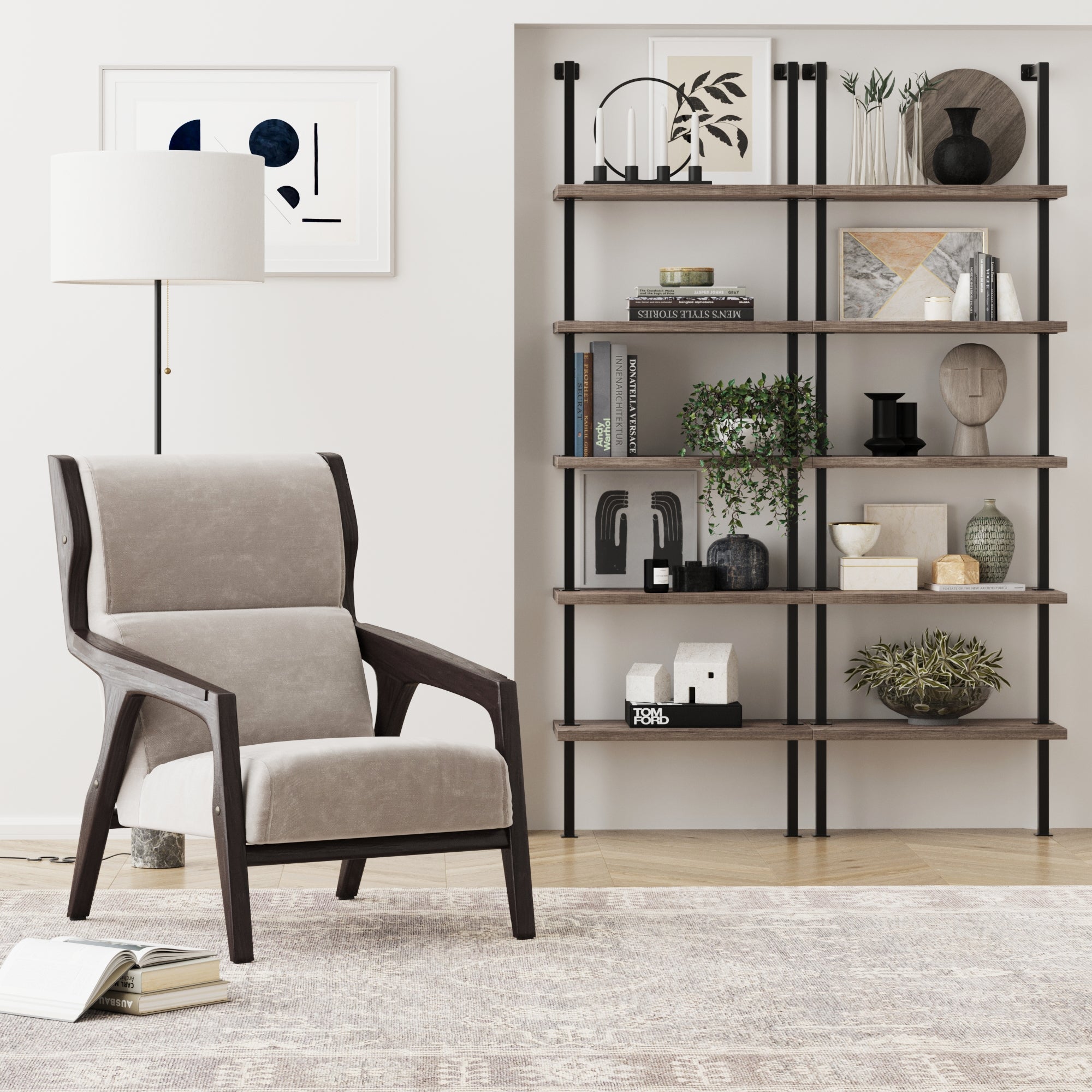 Modern living room with a gray armchair, white lamp, abstract wall art, and the Nathan James 5-Shelf Bookshelf in Light Gray Oak/Matte Black, displaying books and decor. The space features neutral colors and minimalistic style.