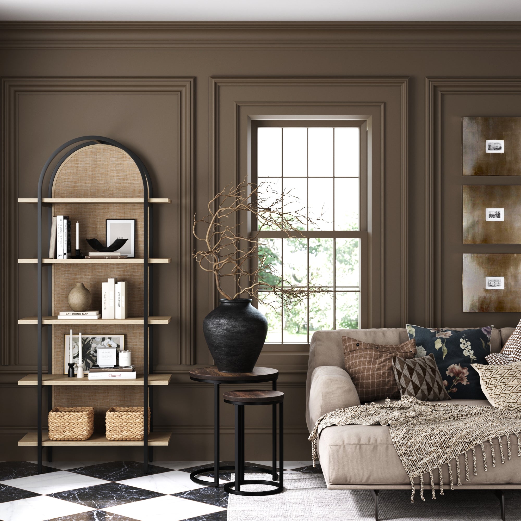 A stylish living room with brown paneled walls, an arched bookshelf, a beige sofa with patterned pillows and a throw, a black vase with twigs on nesting tables, and checkered black-and-white tile flooring.