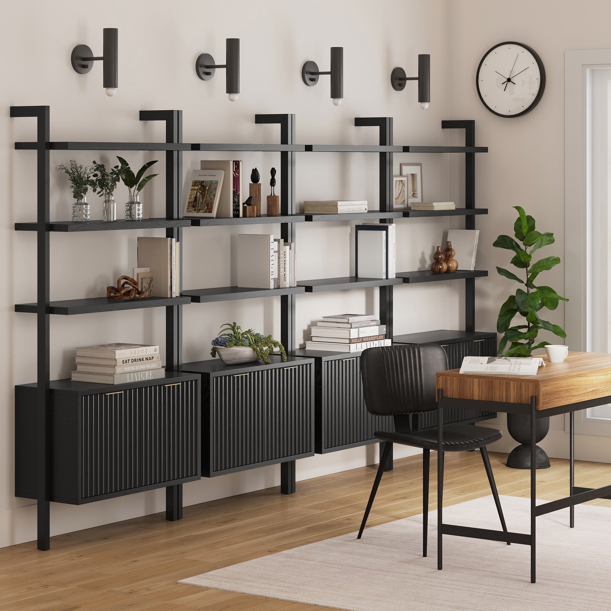 Modern home office with Nathan James Mid-Century Fluted Wall Bookshelves with Doors Black (Set of 4), decorative objects, books, wooden desk with black chair, wall clock, four wall lamps, a potted plant, and a light rug on hardwood floors.