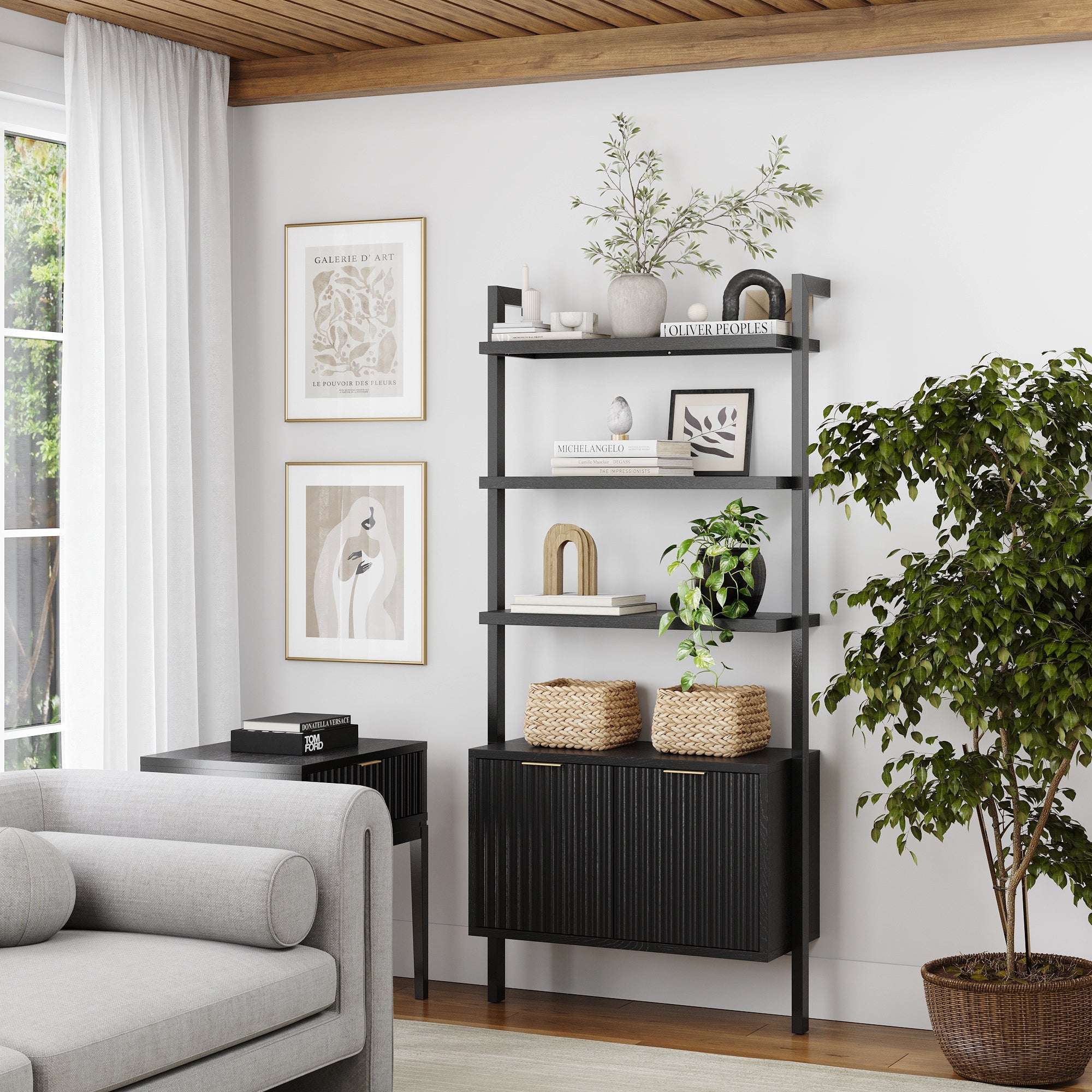 A modern living room featuring a light gray sofa, the Nathan James Mid-Century Fluted Wall Bookshelf with Doors in black adorned with plants, baskets, books, and decor, a black side table, framed art, large curtained window, and a tall potted plant.
