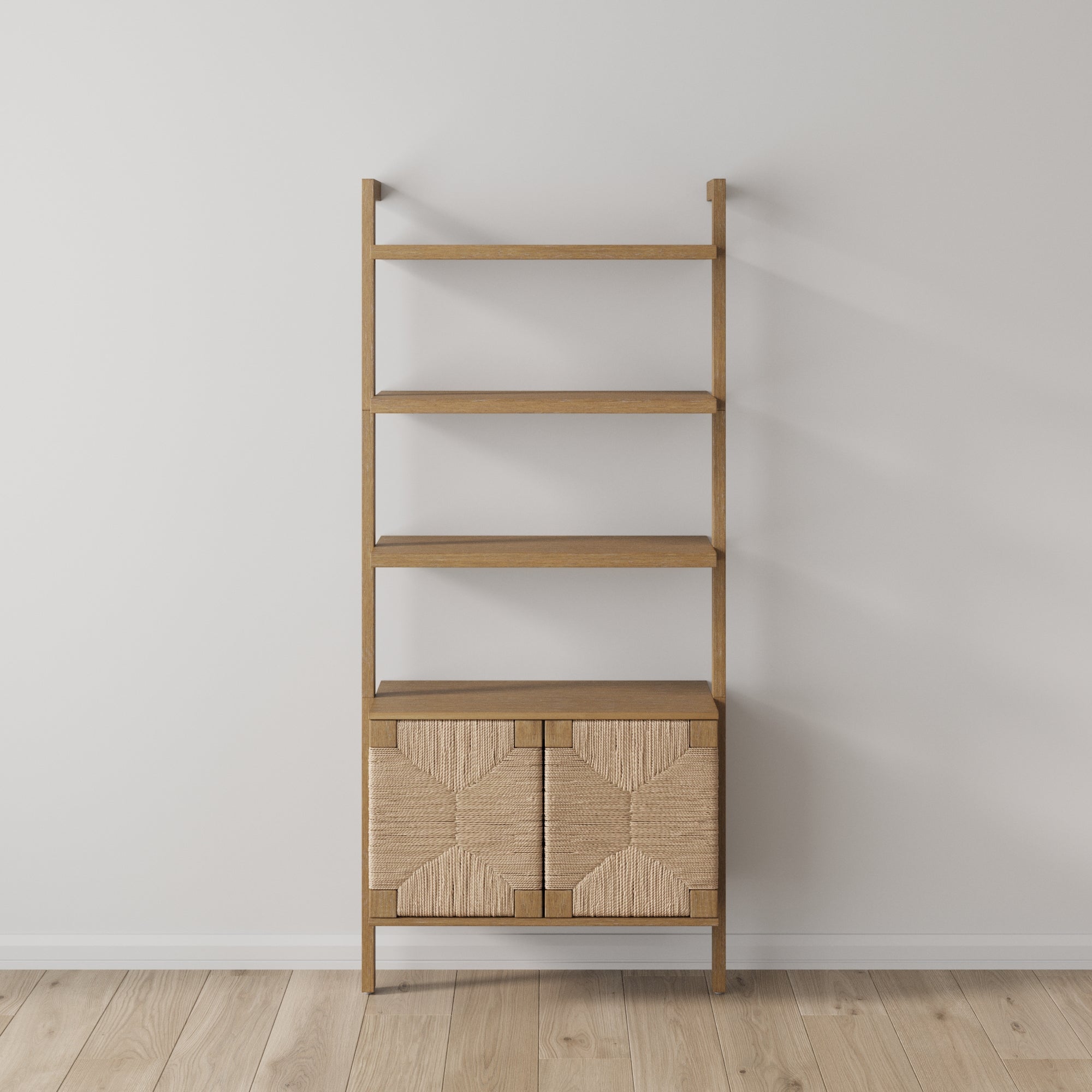 The Nathan James Seagrass Wall Bookshelf with Doors in Light Brown features four open shelves and a lower cabinet with hand-woven seagrass doors, adding boho style against a white wall and light wood floor.
