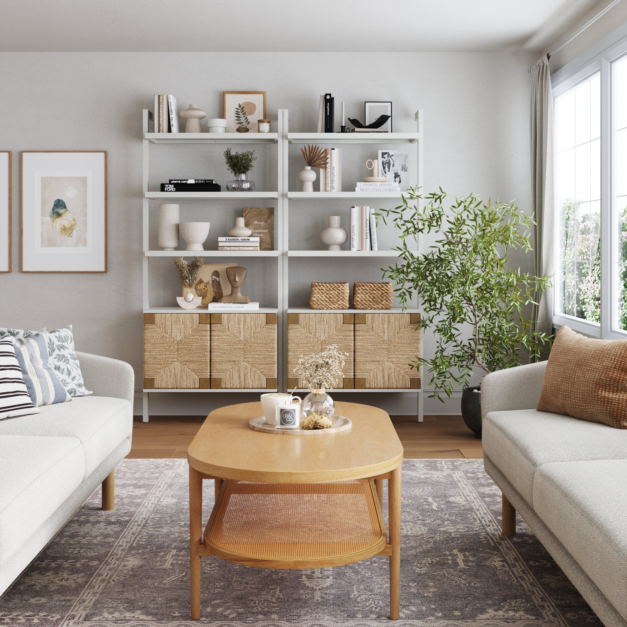 A modern living room with neutral tones features two sofas, a wooden coffee table, and large windows. Two Nathan James Seagrass Wall Bookshelves with Doors in white hold books, vases, and decor, adding style to the bright, cozy space.