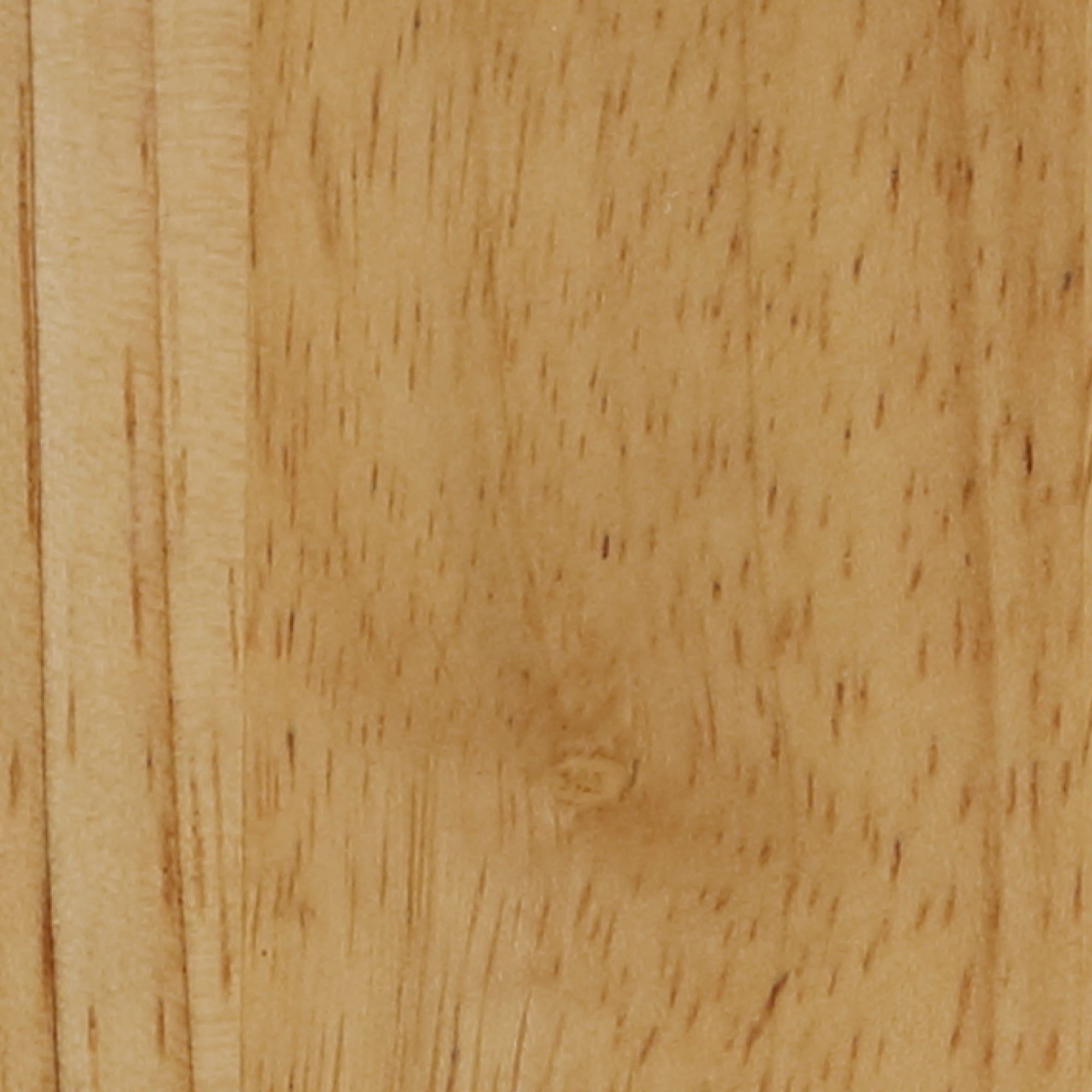 Close-up image of a light brown wooden surface, showing natural grain patterns, subtle knots, and fine texture. The wood appears smooth with a matte finish.