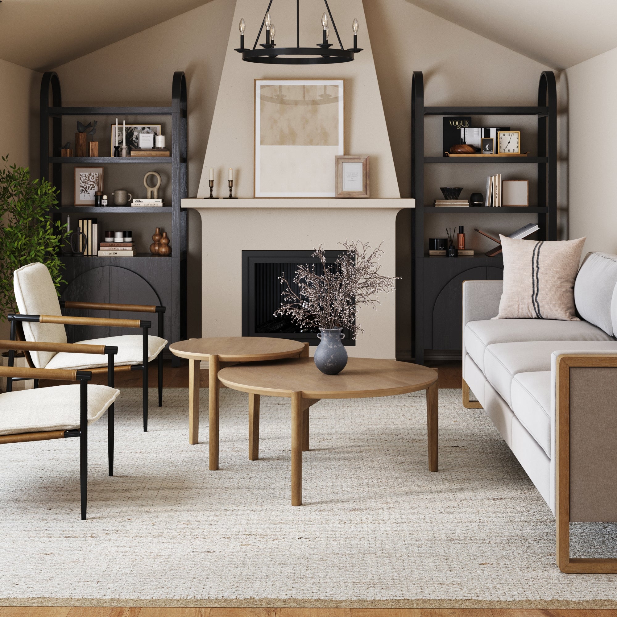 A modern living room with neutral tones features a light sofa, armchairs, two round wooden coffee tables, built-in dark shelves with decor, a fireplace, artwork, and a vase with branches on a textured rug beside Nathan James Mid-Century Arched Bookshelves with Doors in black (set of 2).