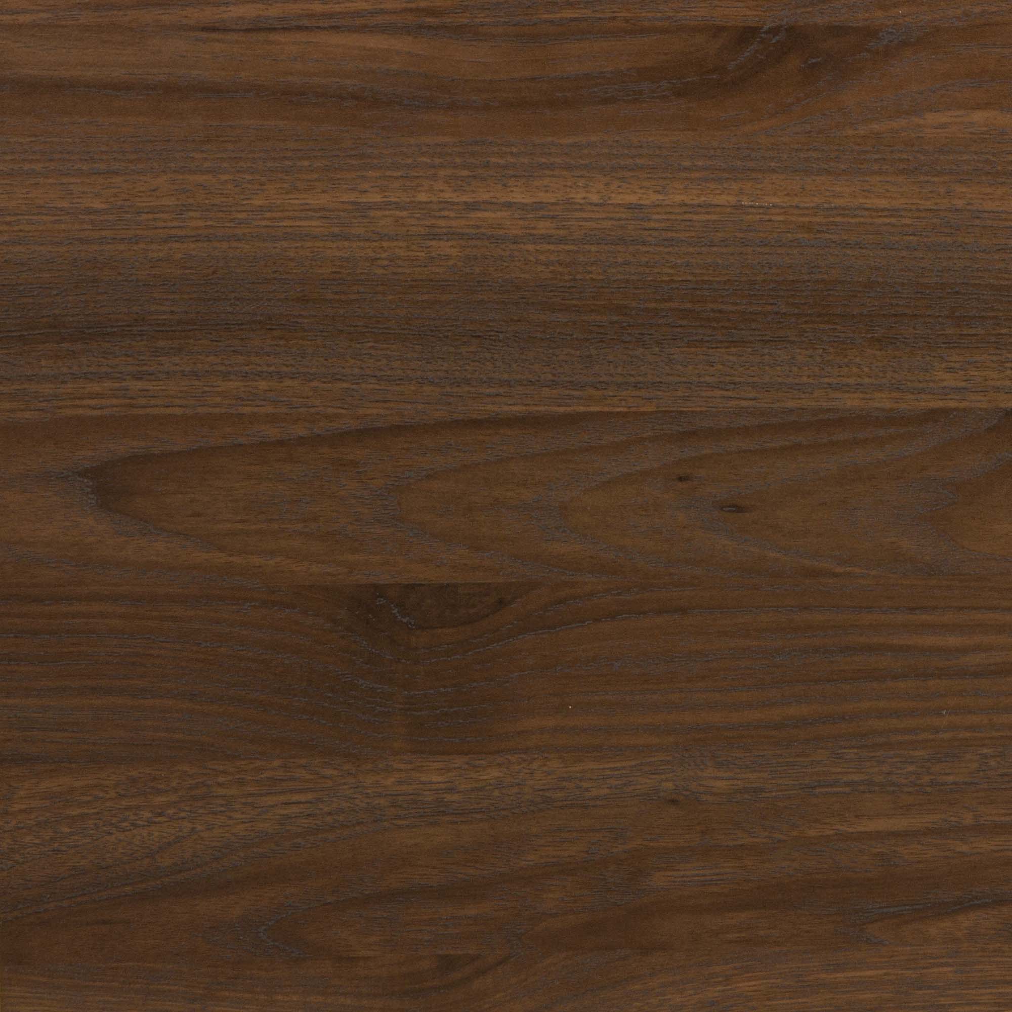 Close-up of a smooth wooden surface with natural grain patterns and rich, medium brown color. The texture features subtle variations in tone and faint, wavy lines typical of polished hardwood.