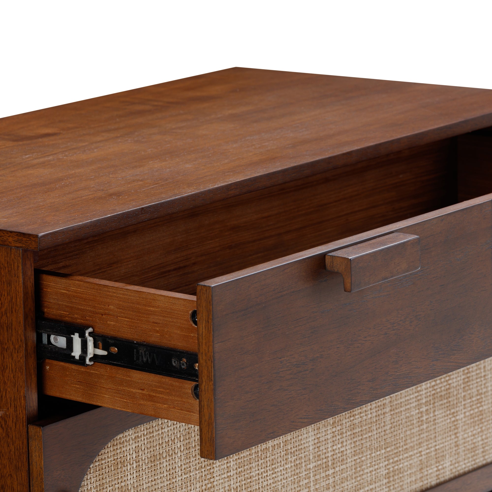 A close-up of a wooden drawer partially open, showing metal slides and tan woven paneling on the front of the furniture piece.