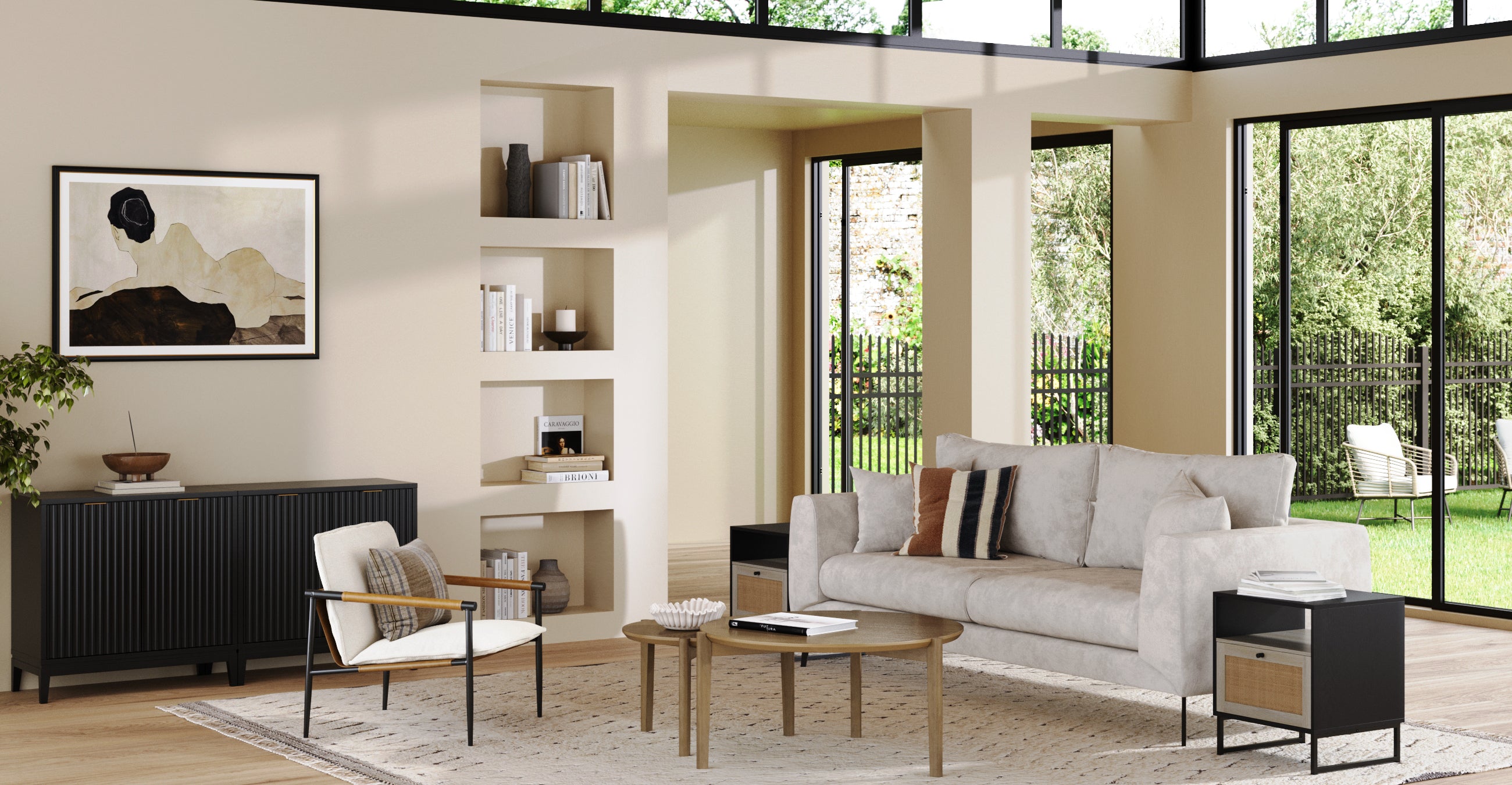 Modern living room with a light sofa, armchair, and coffee tables on a patterned rug. Built-in shelves, artwork, large windows, and glass doors overlook a green garden, filling the space with natural light.