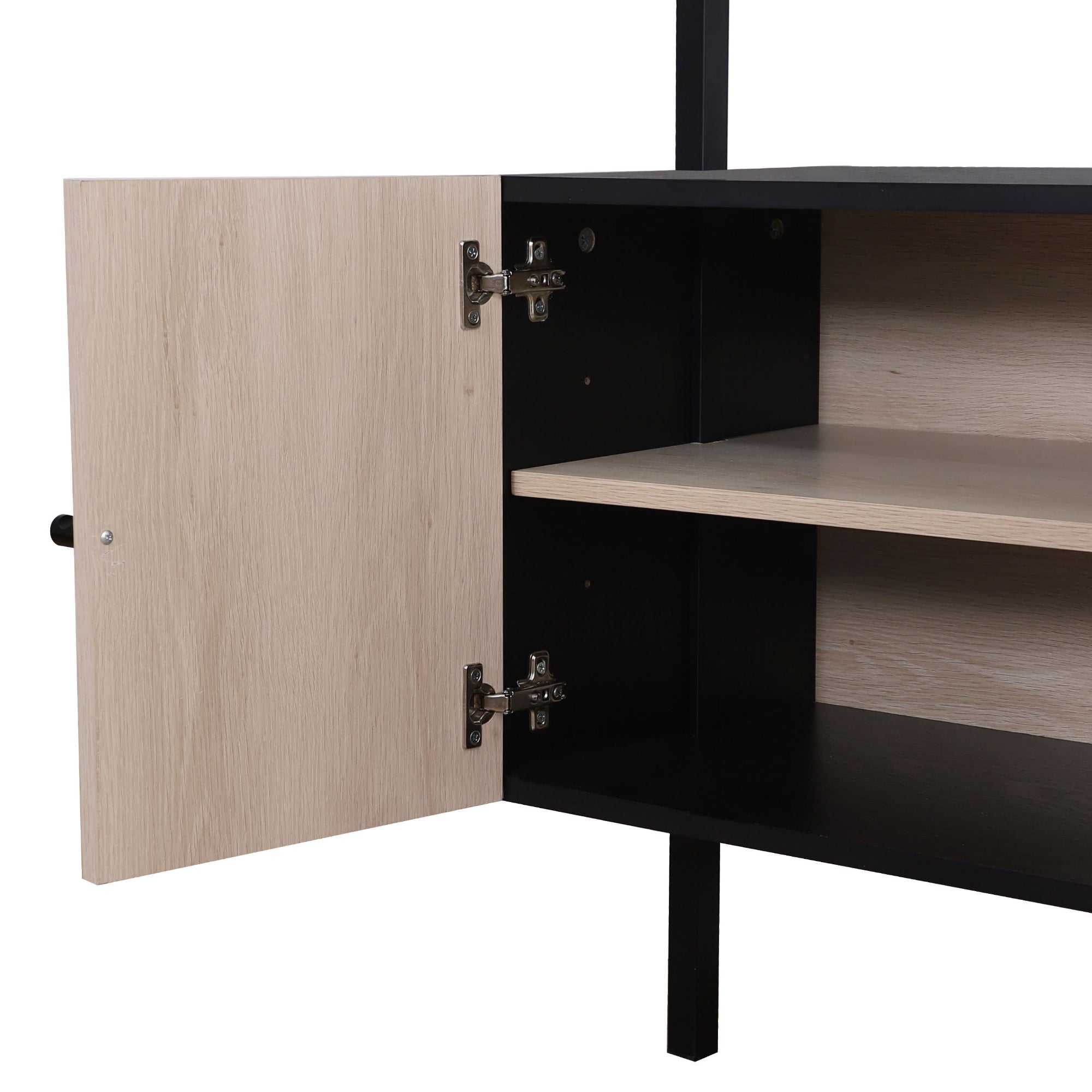 A close-up of a black cabinet with a light wood-colored door open, revealing an inner shelf and metal hinges. The cabinet has simple, modern lines and stands on black legs.