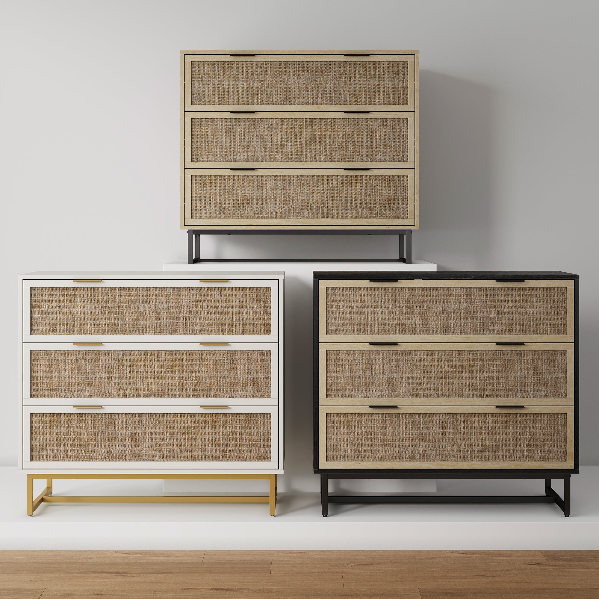 Three modern three-drawer dressers with woven rattan fronts are displayed against a white wall; the dressers have frames in white, natural wood, and black, standing on slim metal legs.