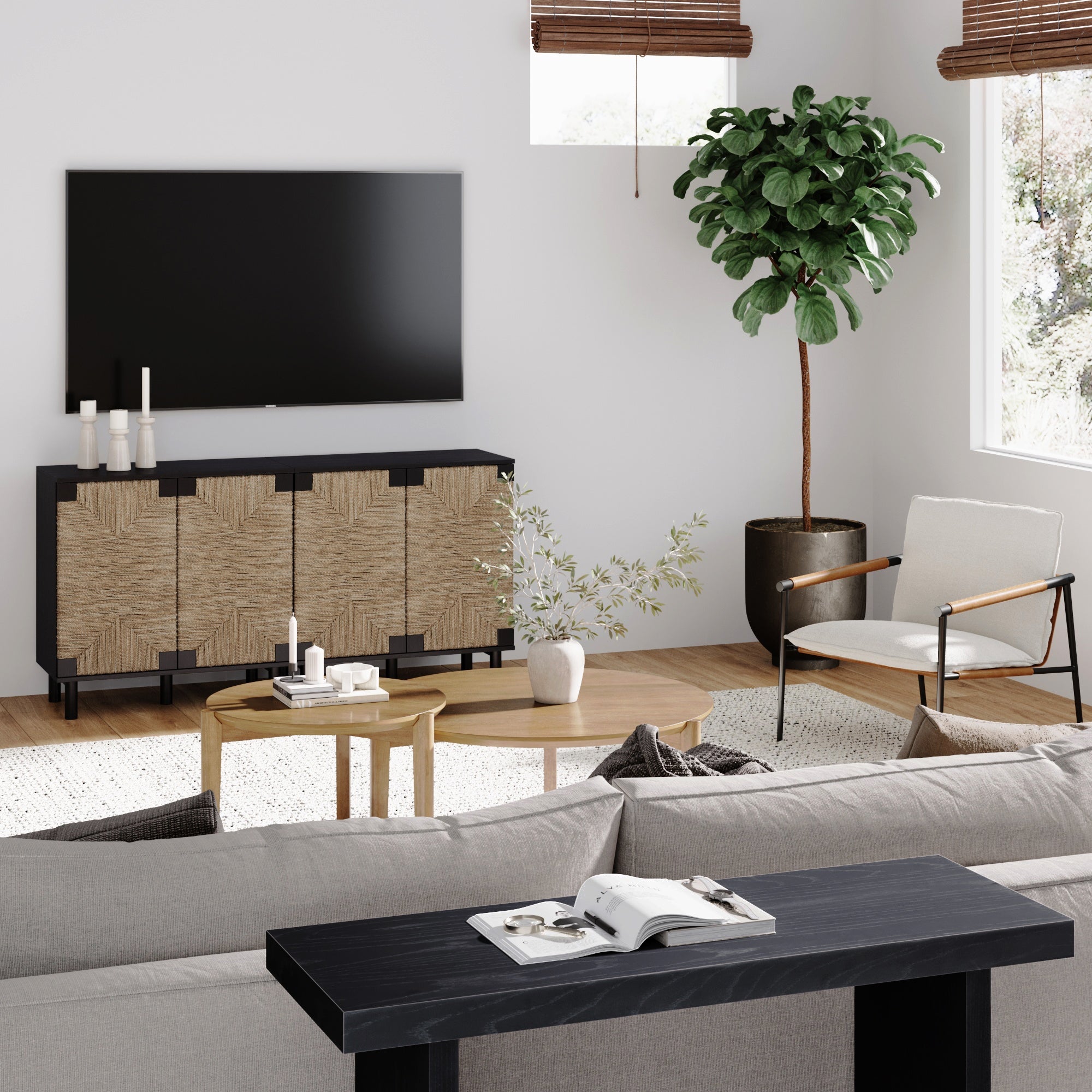 Modern living room with a wall-mounted TV, a sideboard with a geometric pattern, a potted tree, light armchair, wooden coffee tables, neutral sofa, and a console table with an open book and glasses. Natural light fills the space.